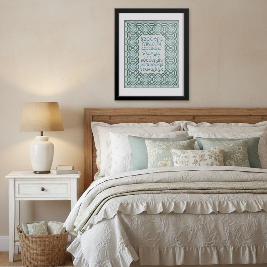 a cozy bedroom with a large bed, a nightstand, and a framed print on the wall.