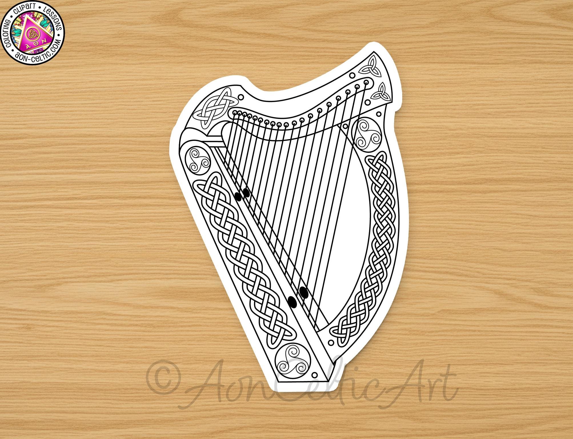 A black and white illustration of a harp with intricate Celtic designs on the body and strings.