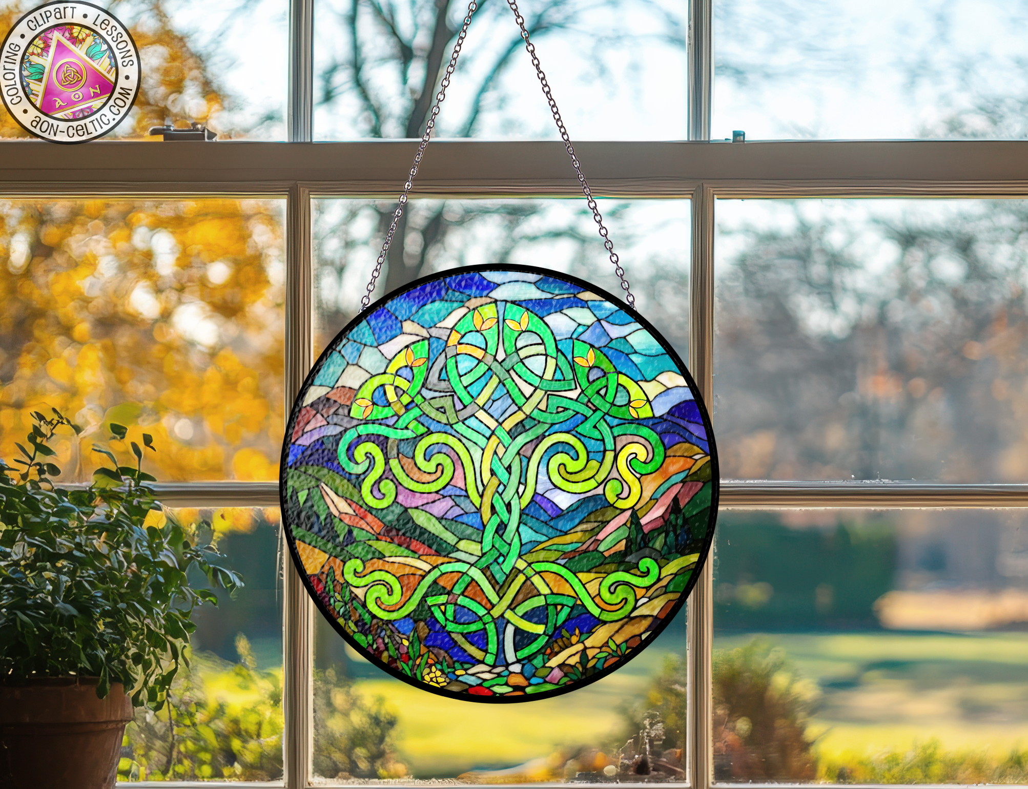 a stained glass sun catcher hanging from a window