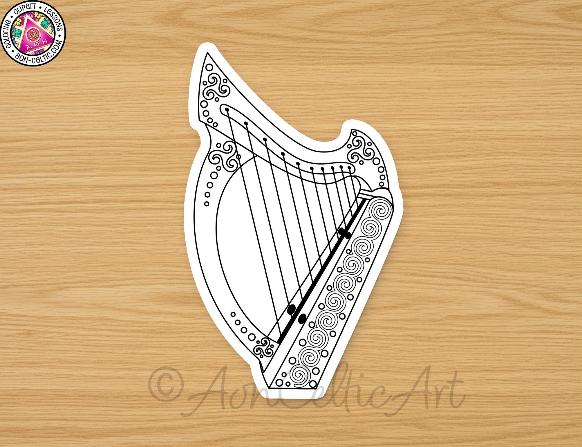 A stylized illustration of a harp is displayed on a wooden surface.