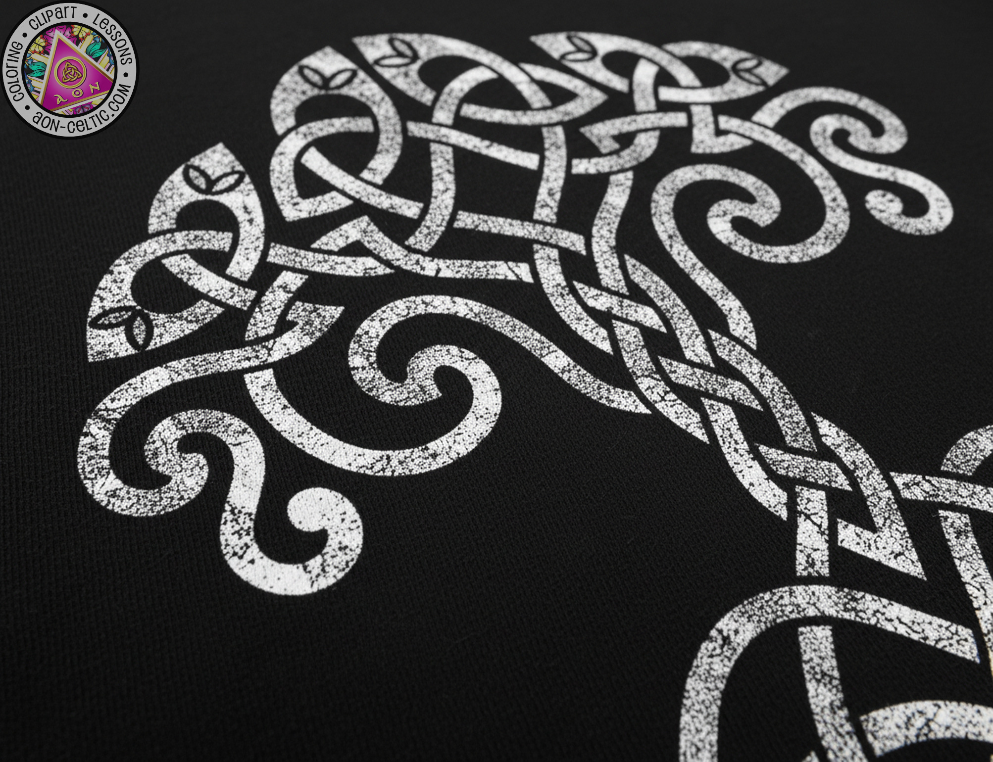 a close-up view of a detailed, intricate white design resembling a tree or a Celtic knot pattern on a black background.
