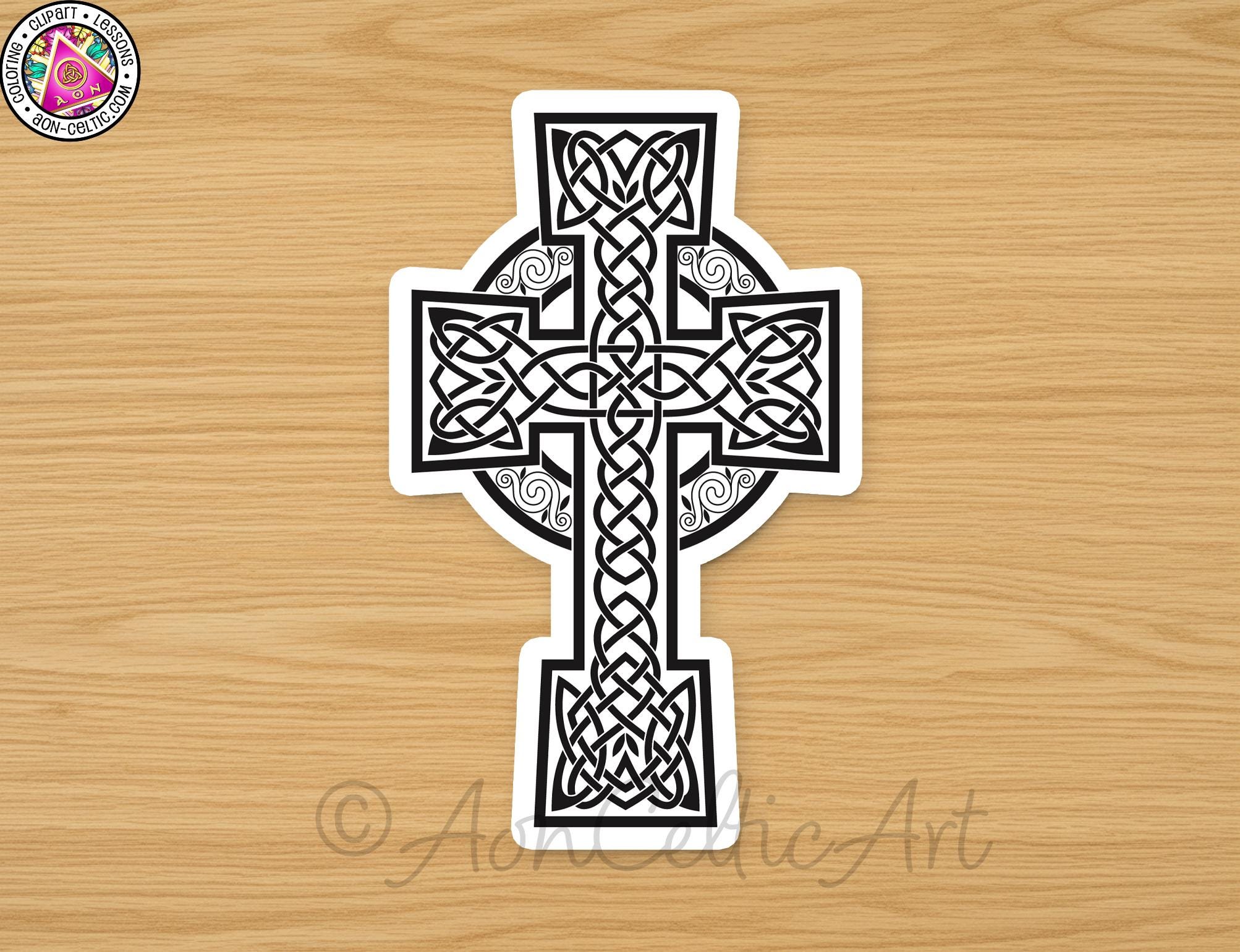 A sticker depicting a Celtic cross design on a wooden surface.