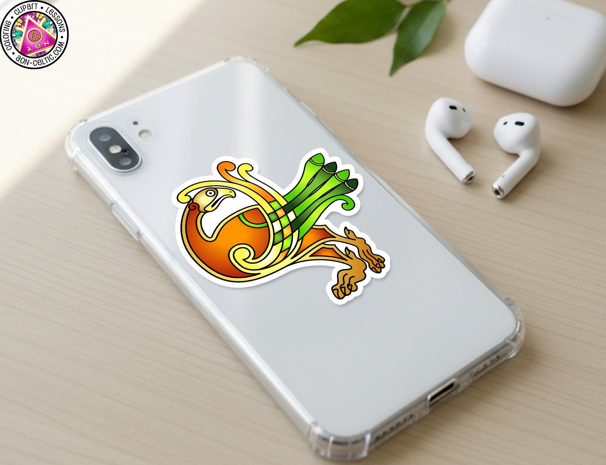 a smartphone with a colorful sticker of a bird on its back cover, along with a pair of white earbuds and a white phone case.