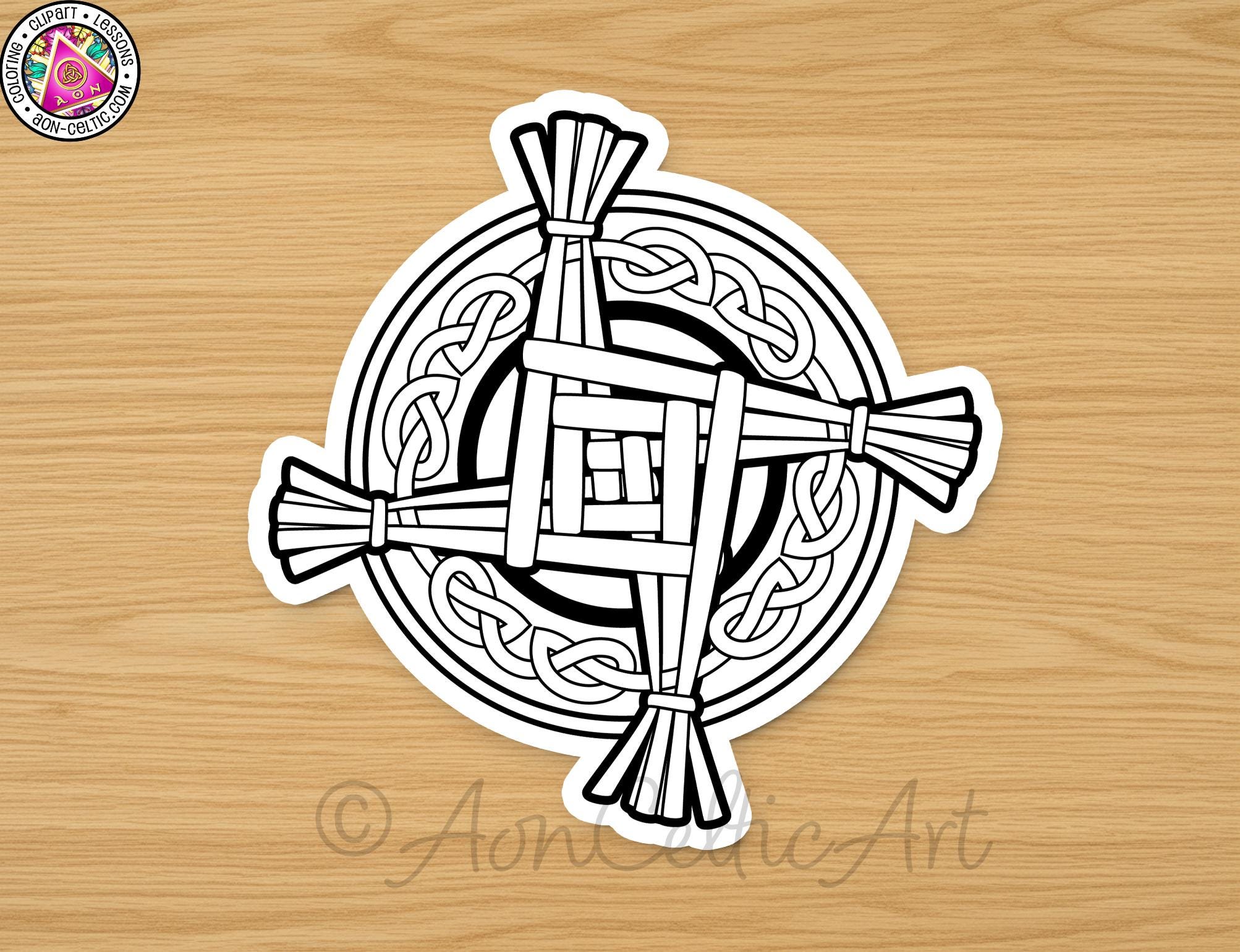 A sticker depicting a Celtic cross design on a wooden surface.