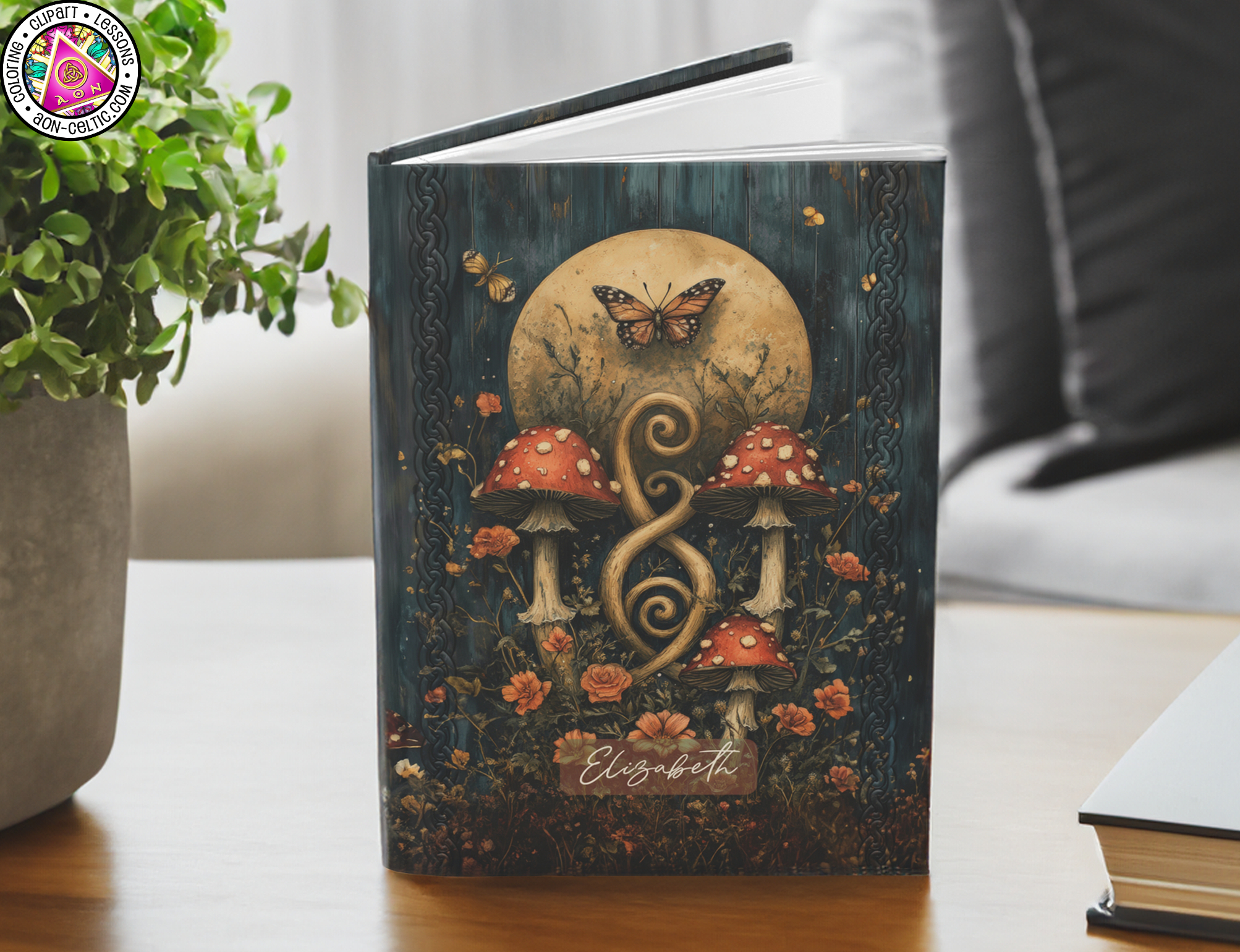 a book sitting on a table with a plant in front of it