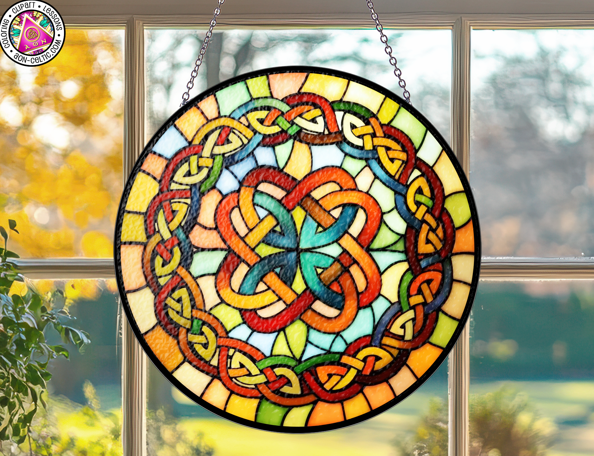 a stained glass sun catcher hanging from a window