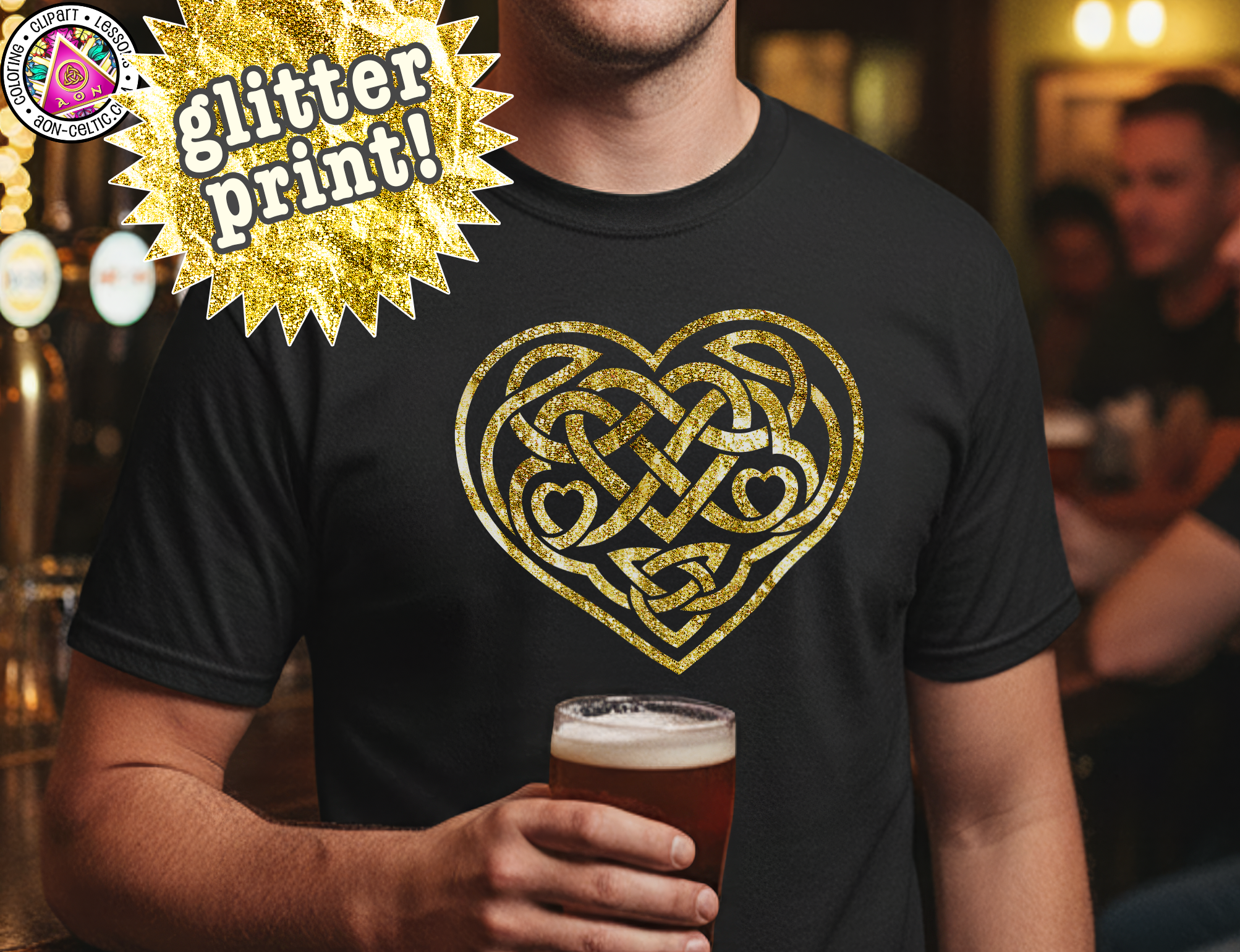 A man wearing a black t-shirt with a gold heart design and holding a glass of beer in a bar setting.