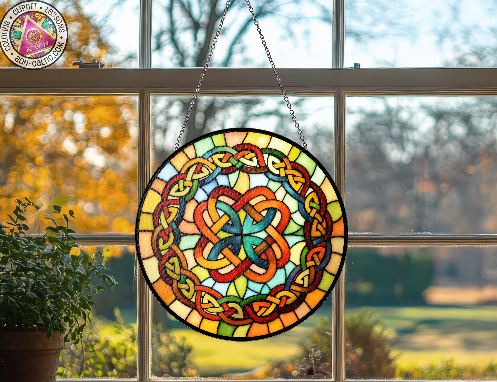 a stained glass sun catcher hanging from a window