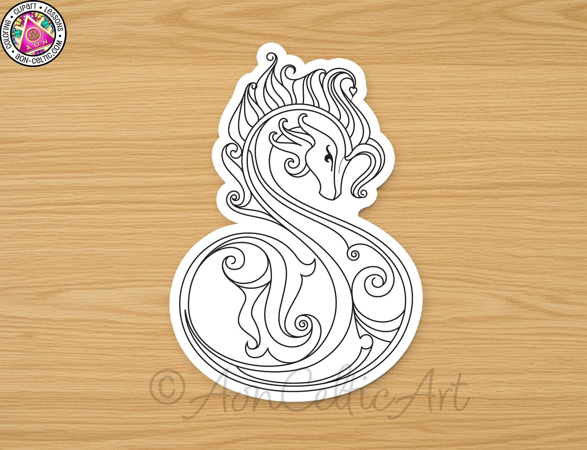 A stylized black and white illustration of a decorative design resembling a stylized letter 'S' or a similar shape, placed on a wooden surface.