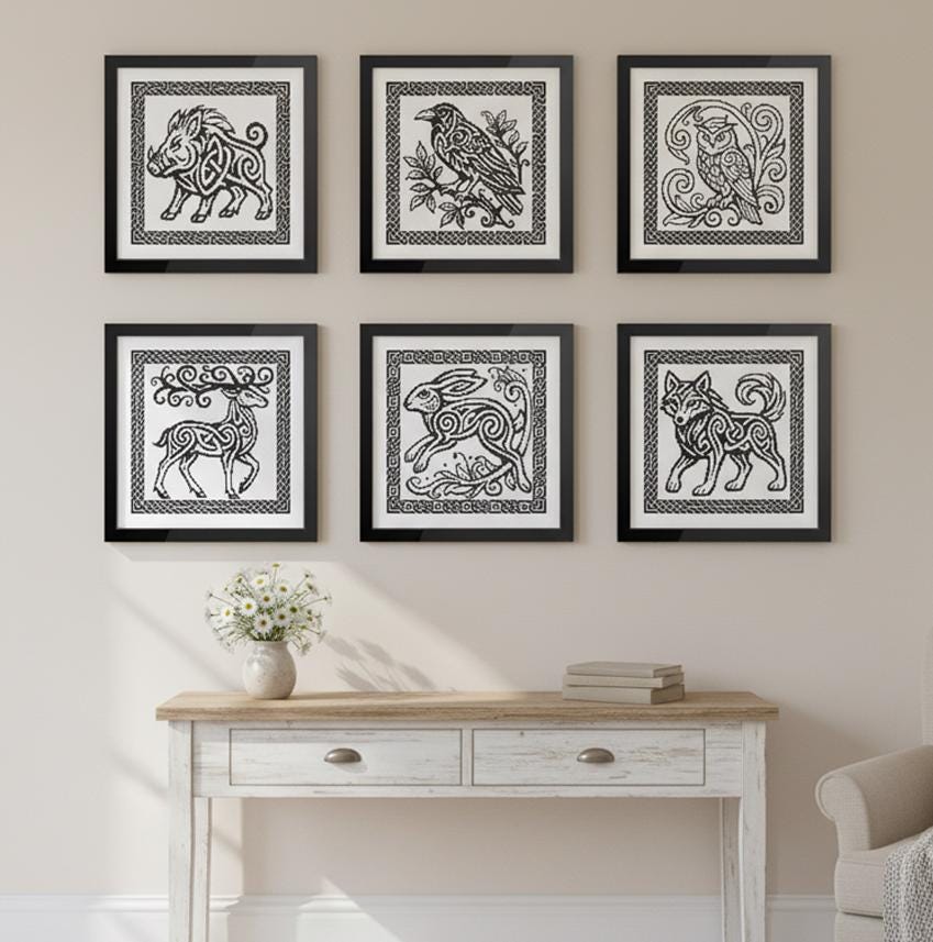 a set of six framed artworks depicting various animals, including a pig, a bird, a cat, a deer, a rabbit, and a wolf, arranged in a row on a wall above a white wooden table.