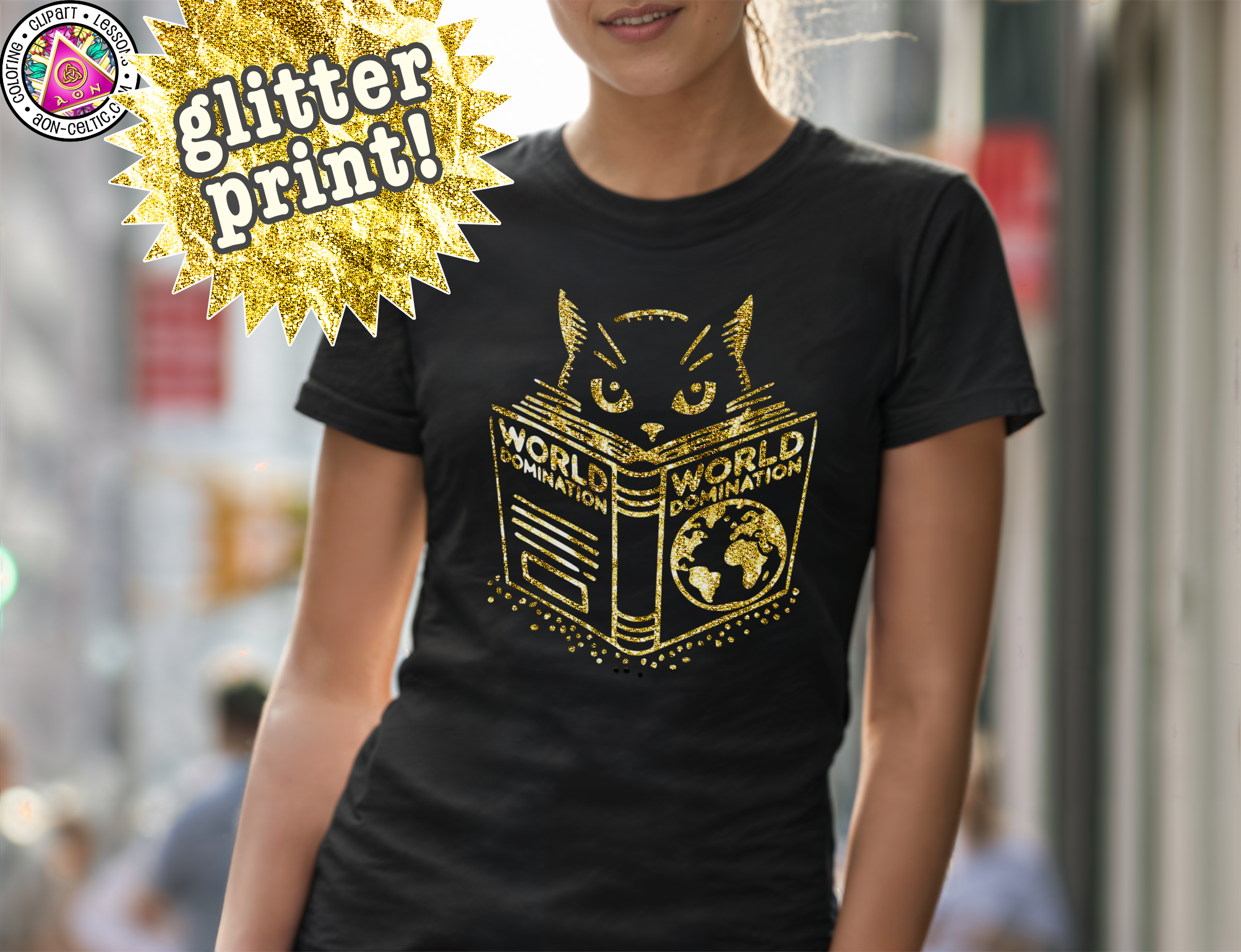 A woman wearing a black t-shirt with a gold design of a cat's face and the text "WORLD DOMINATION" printed on it.