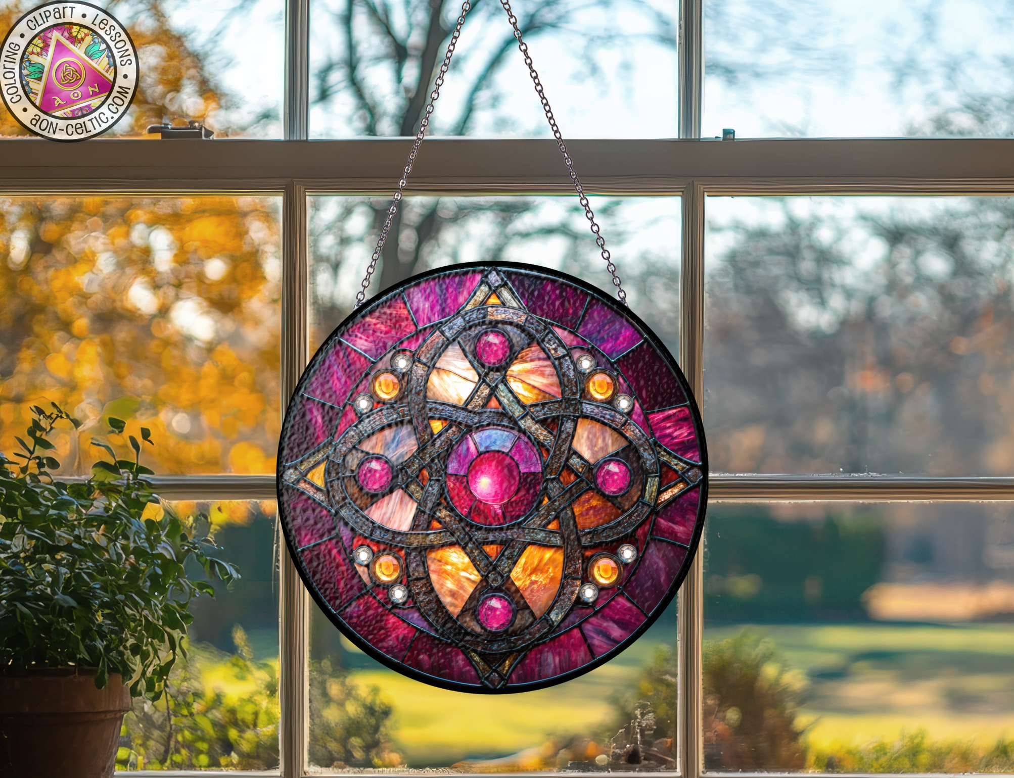 a stained glass sun catcher hanging from a window