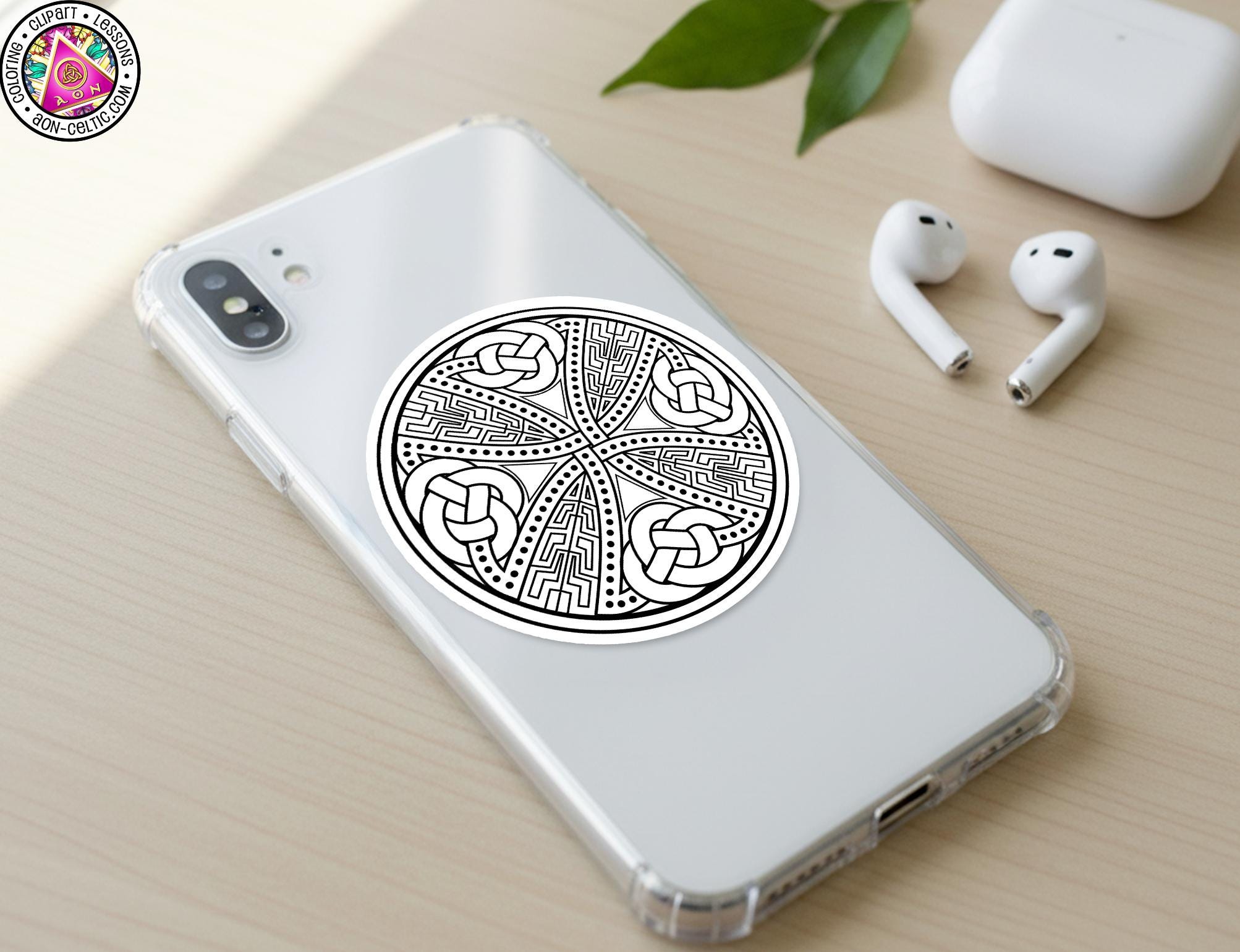 a smartphone with a sticker on the back cover, along with a pair of earbuds and a white earbud case.