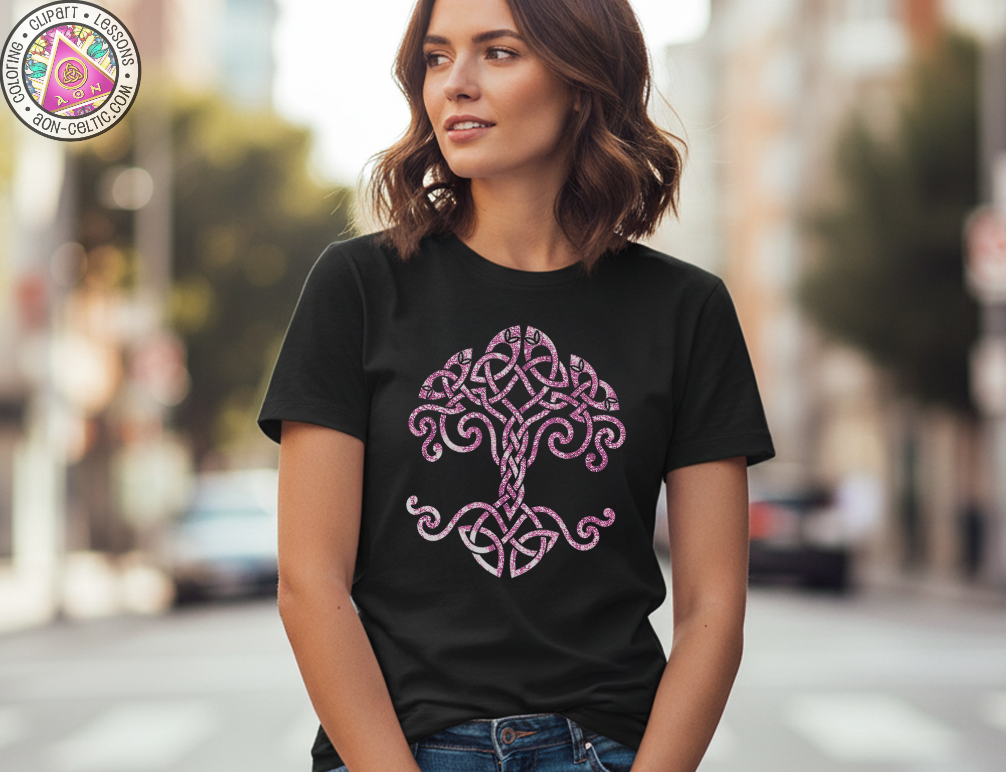 A woman wearing a black t-shirt with a pink tree design stands on a city street.