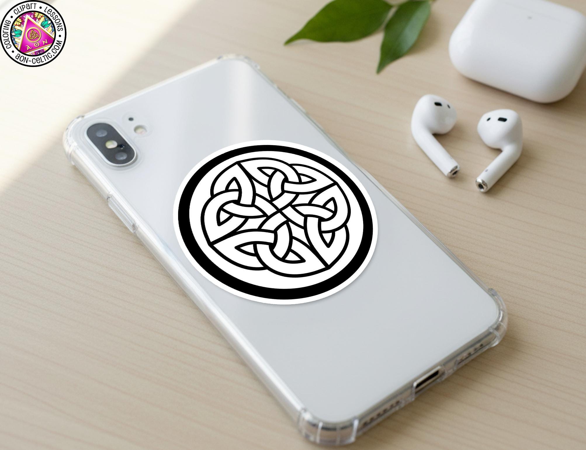 a smartphone with a sticker of a Celtic knot design on its back cover, along with a pair of white earbuds and a white phone case.
