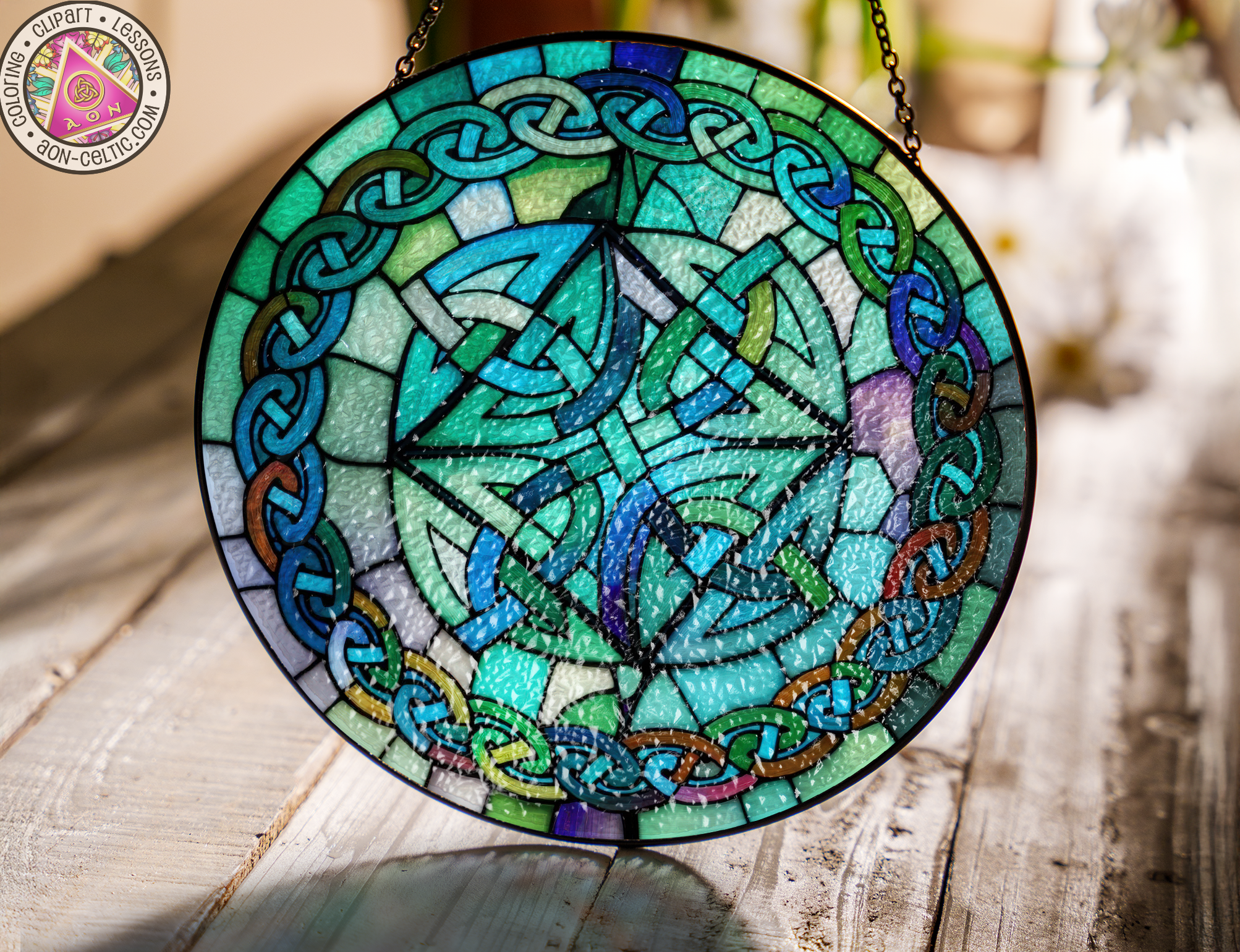 a stained glass plate hanging on a chain