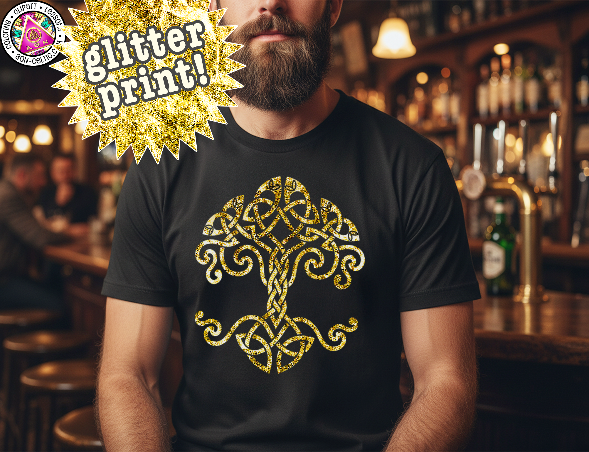 A man wearing a black t-shirt with a gold tree design printed on it, standing in a bar setting.