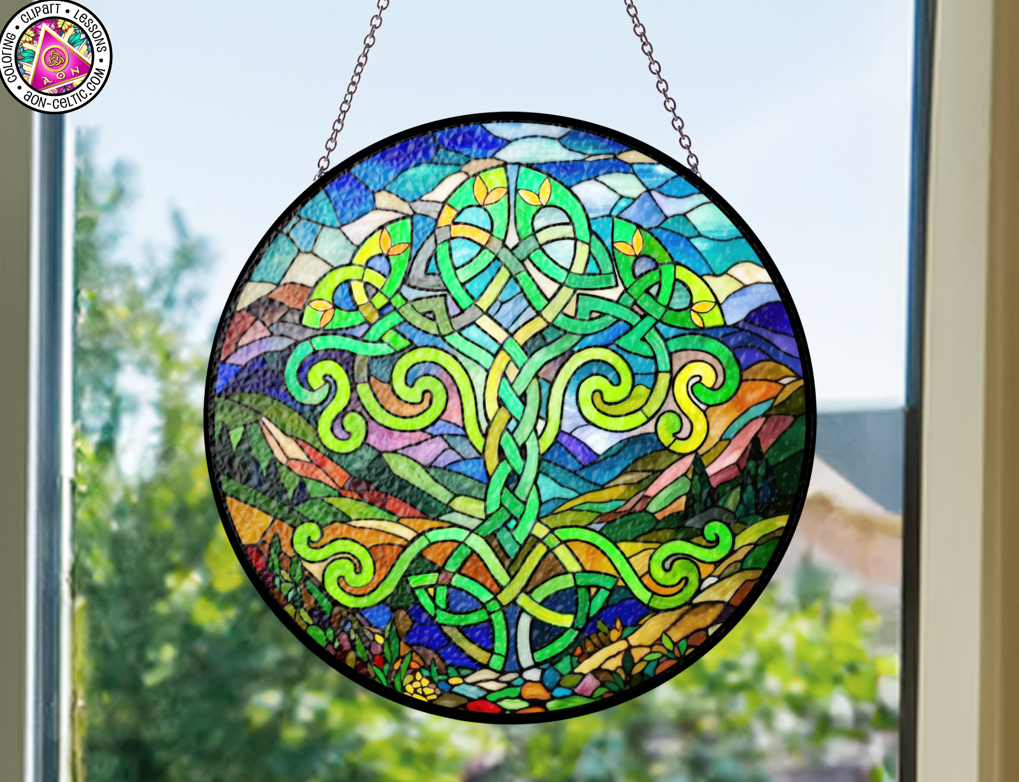 a stained glass sun catcher hanging from a window
