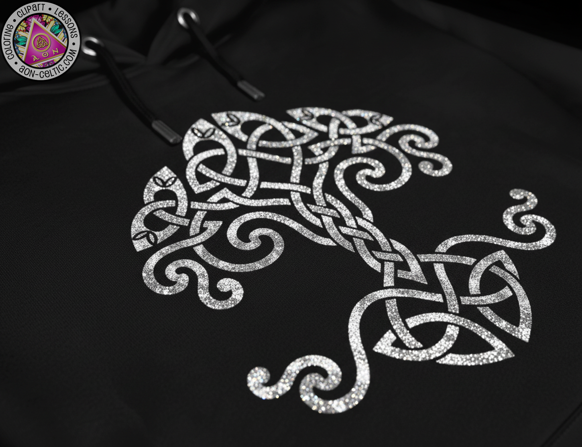 a close-up view of a black fabric with a white, intricate tree-like design in the center.