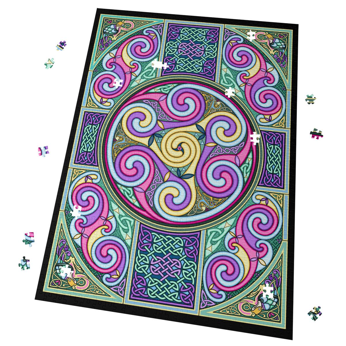 a vibrant, intricate Celtic-inspired design with swirling patterns in shades of pink, purple, green, and yellow. The design is surrounded by scattered puzzle pieces, suggesting that it is a completed puzzle.