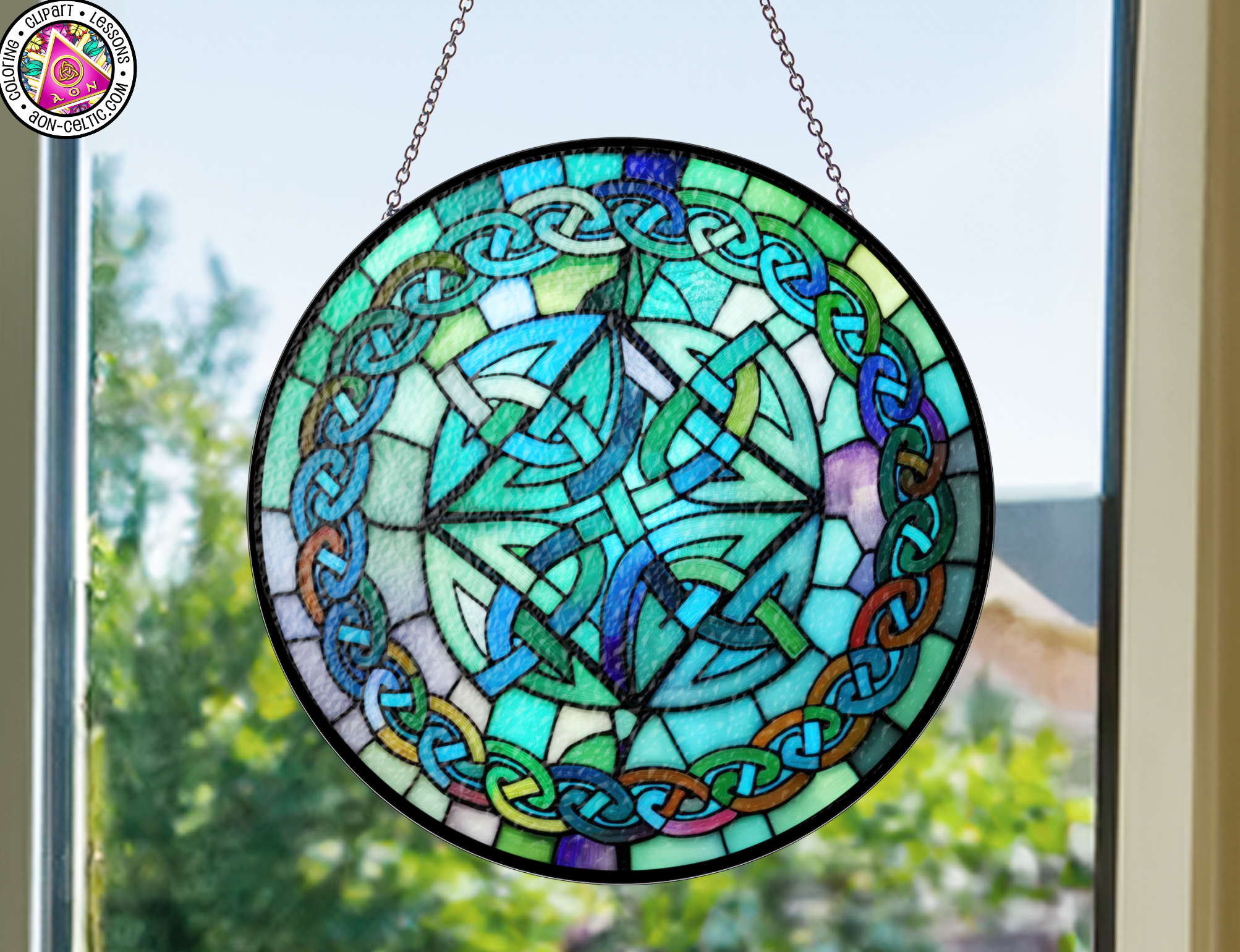 a stained glass sun catcher hanging from a window