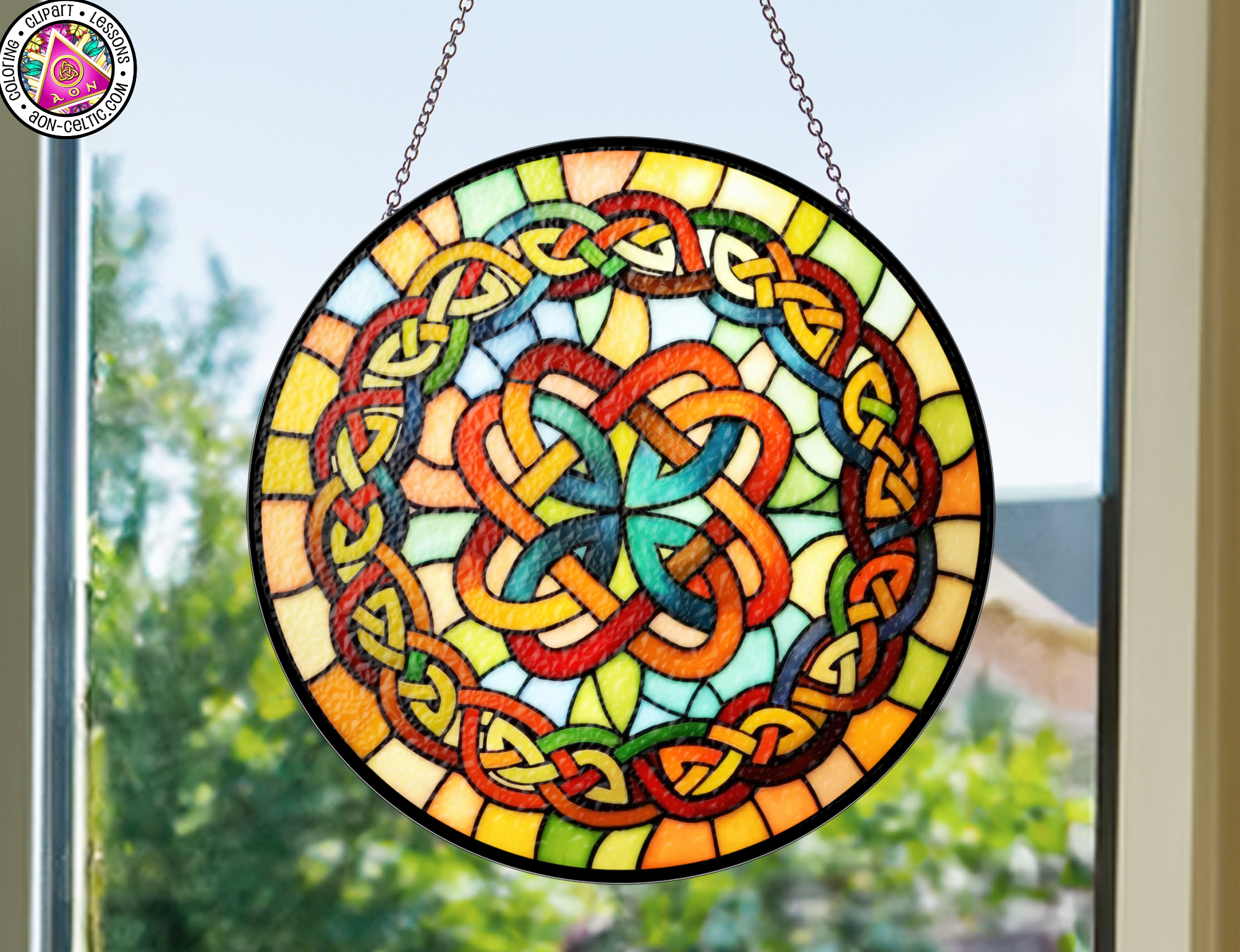 a stained glass sun catcher hanging from a window