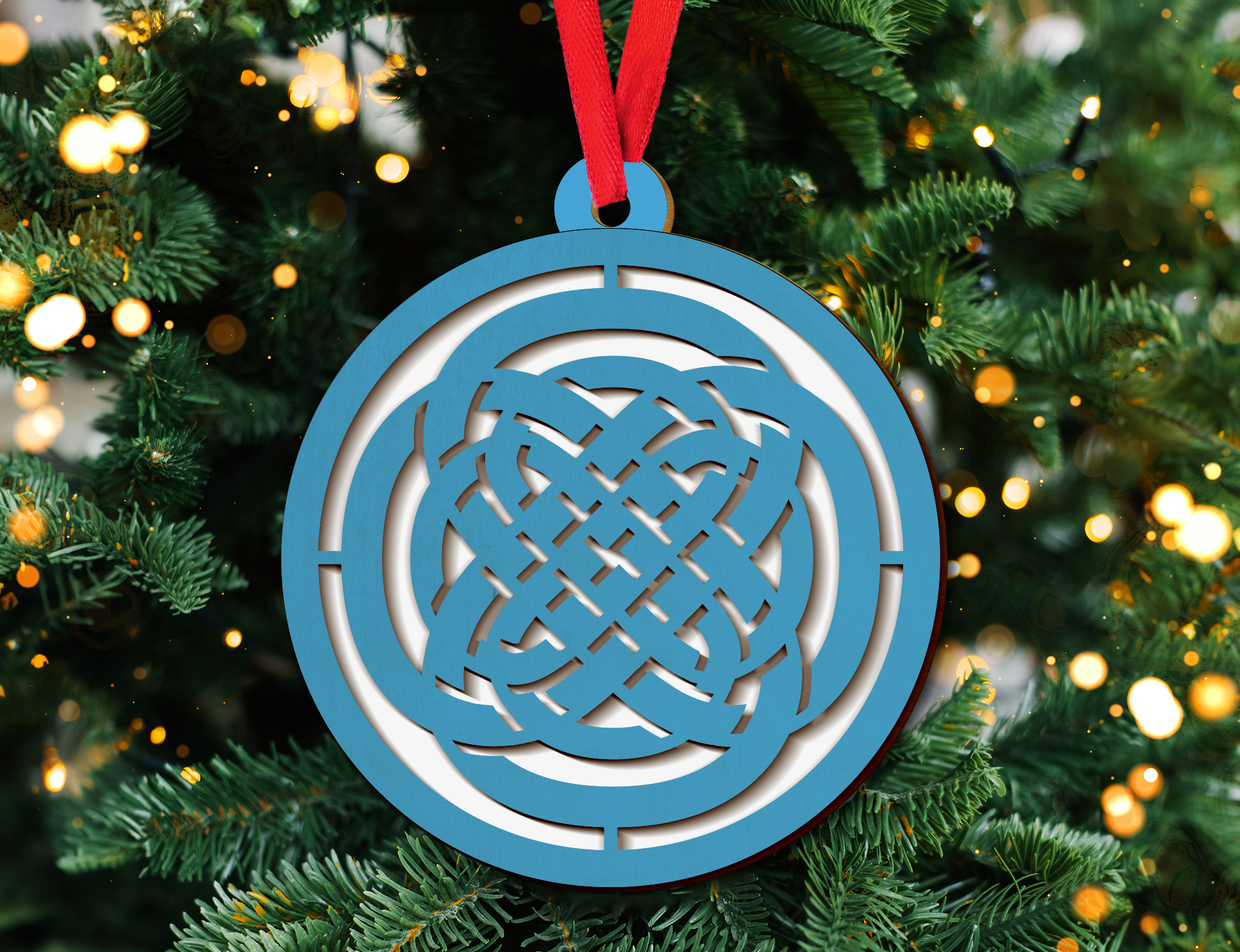 a blue ornament hanging from a christmas tree
