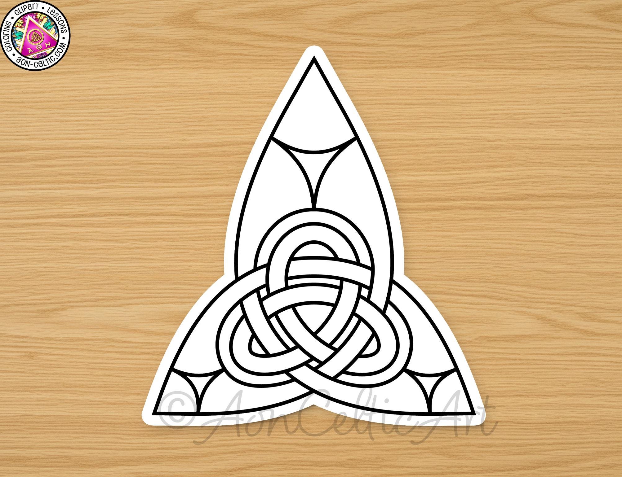A white triangle with a knot design in the center, placed on a wooden surface.