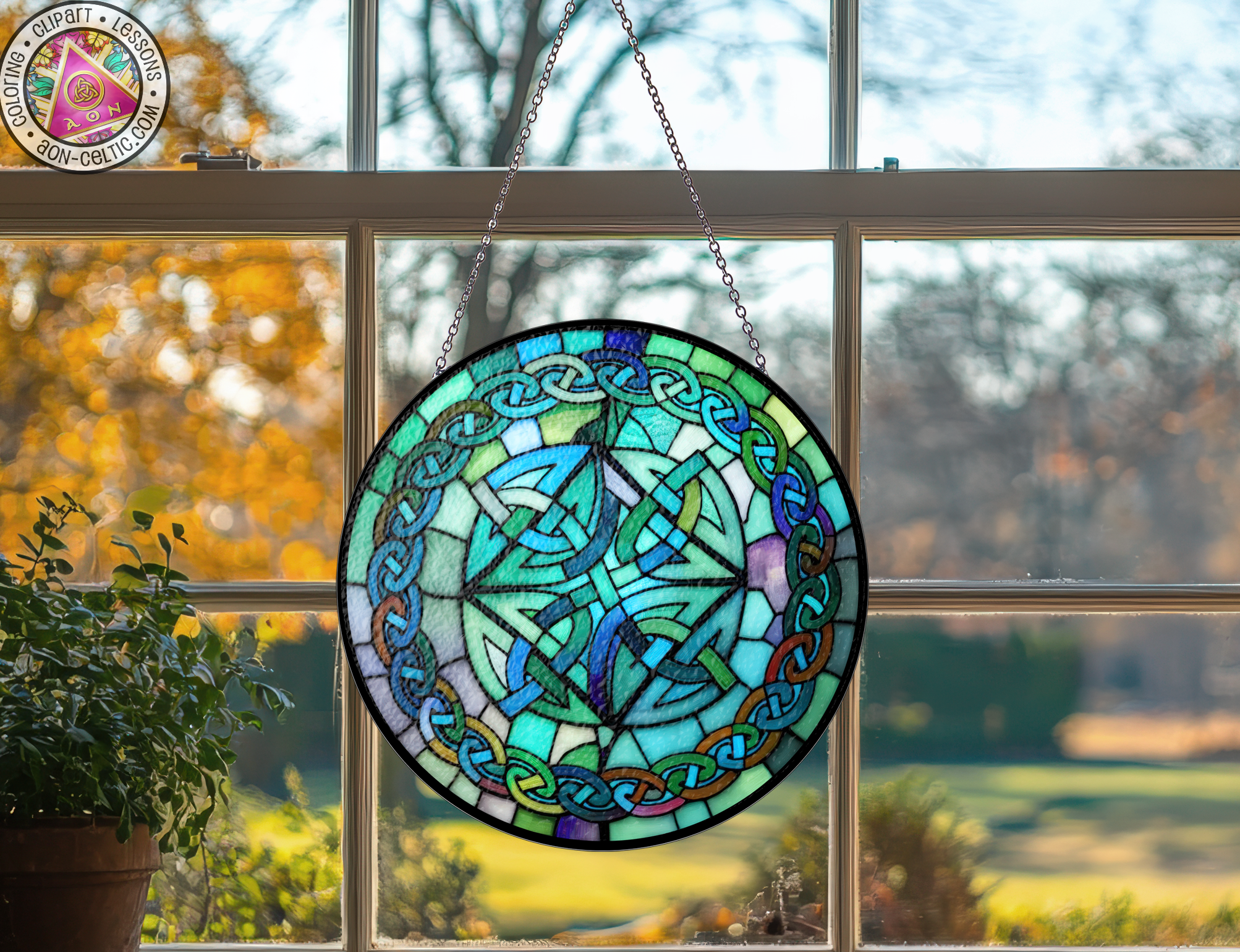 a stained glass sun catcher hanging from a window