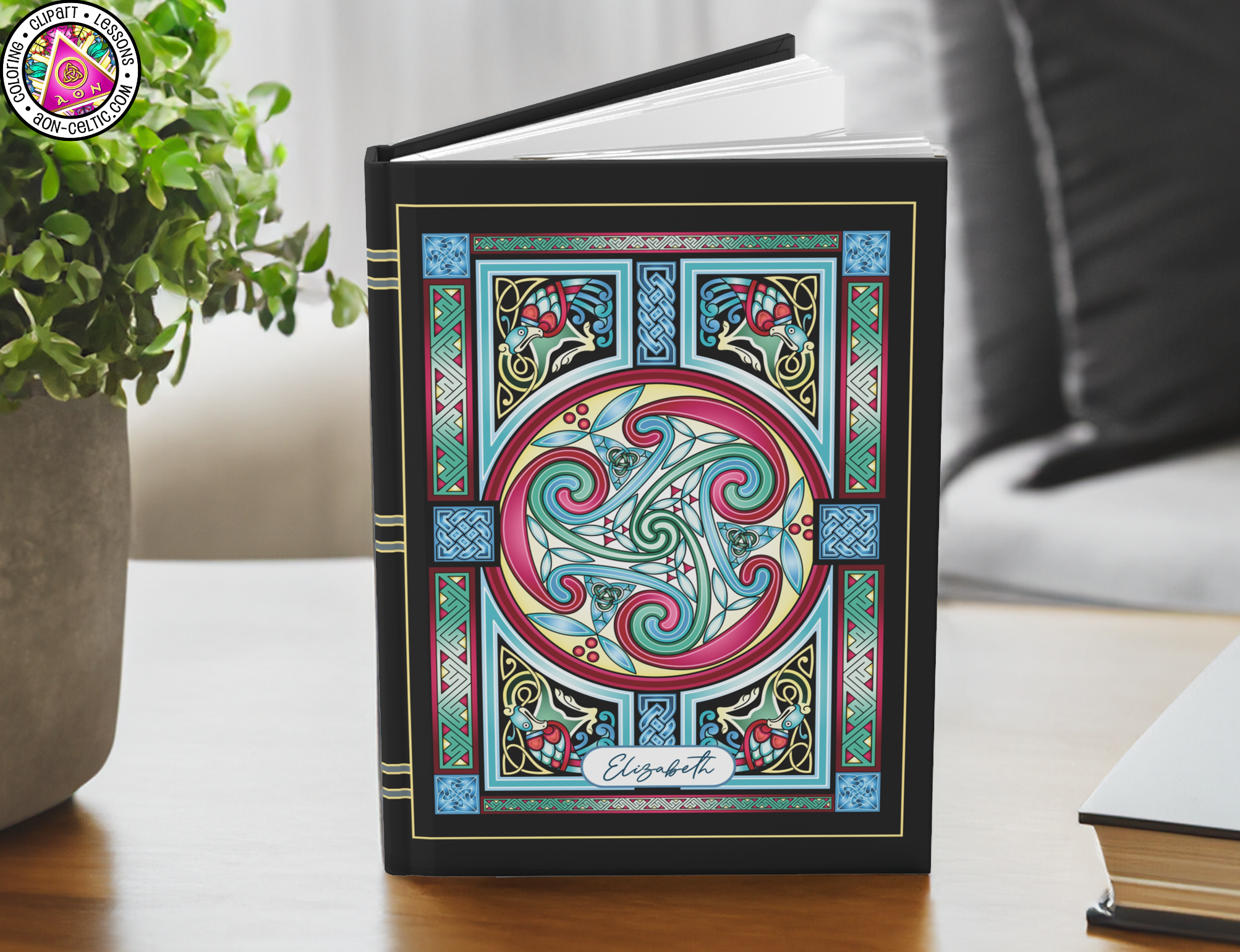 a book sitting on top of a table next to a potted plant