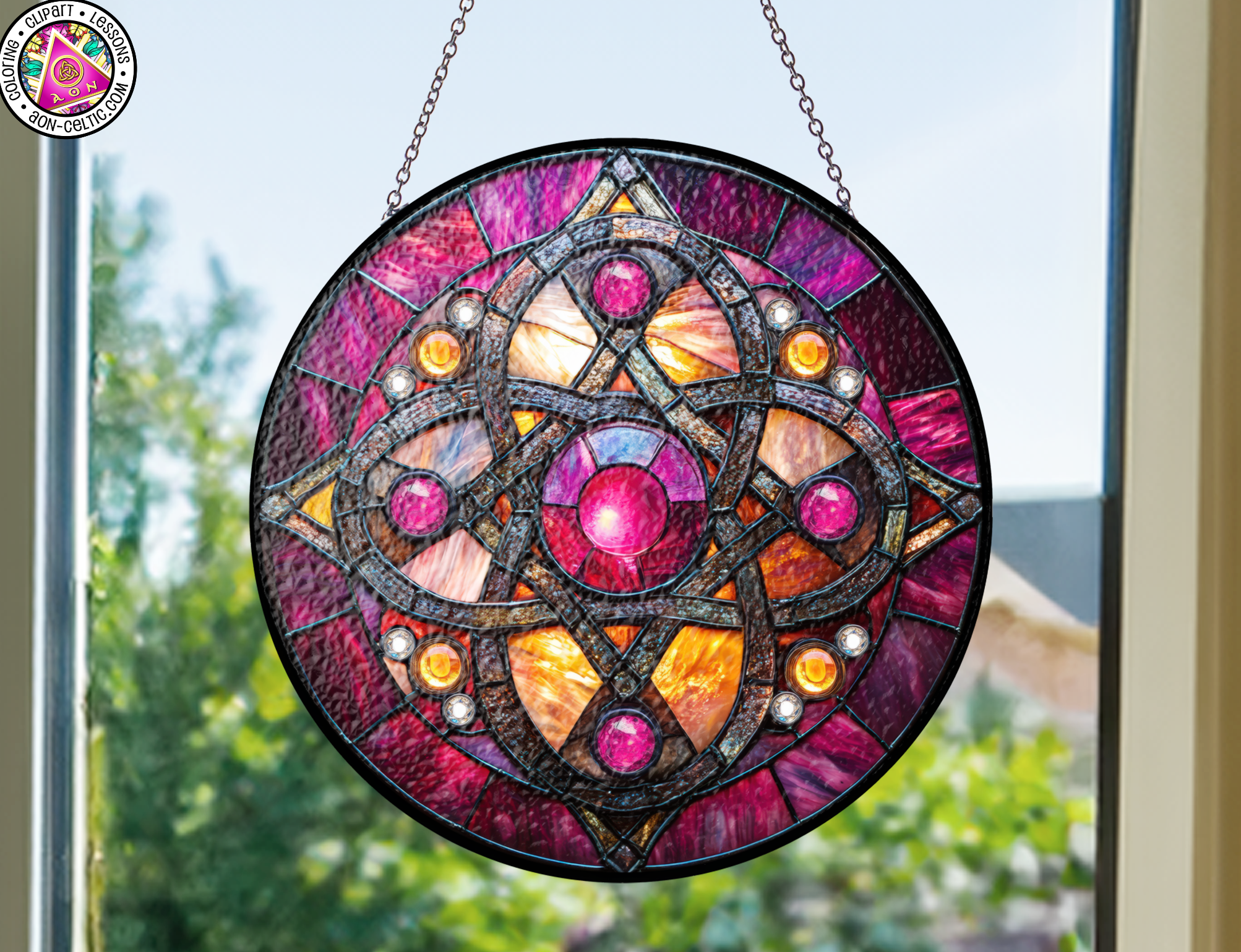 a stained glass sun catcher hanging from a window