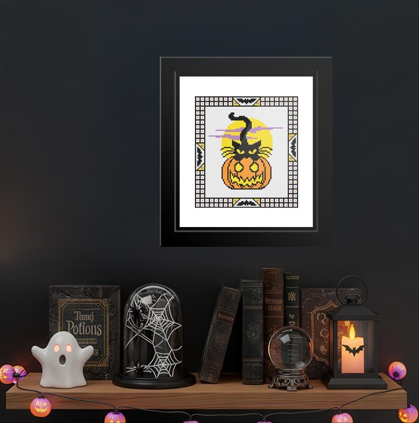 a shelf with various Halloween-themed items, including a framed picture of a jack-o-lantern, a spider web decoration, a lantern, and a ghost.