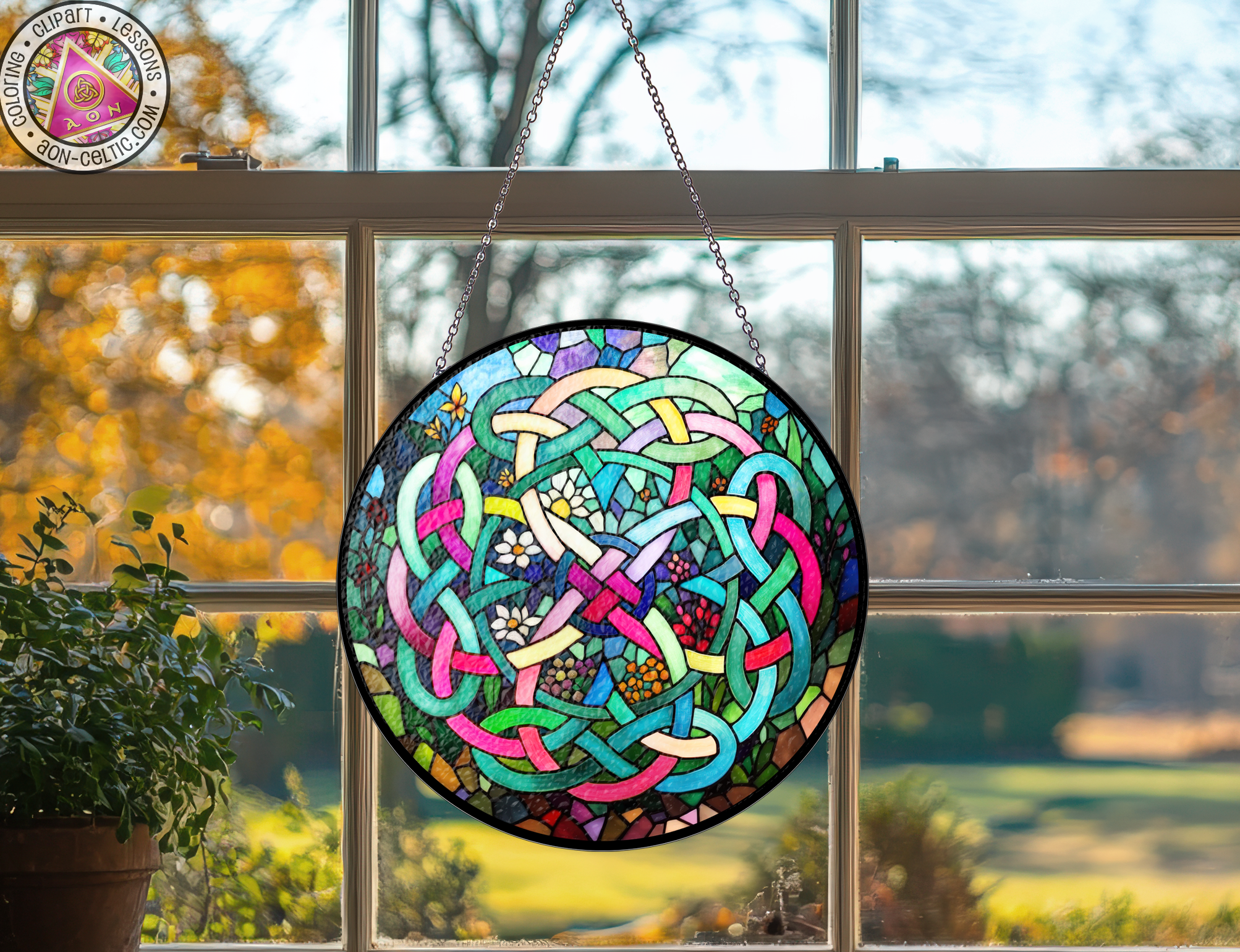 a stained glass sun catcher hanging from a window