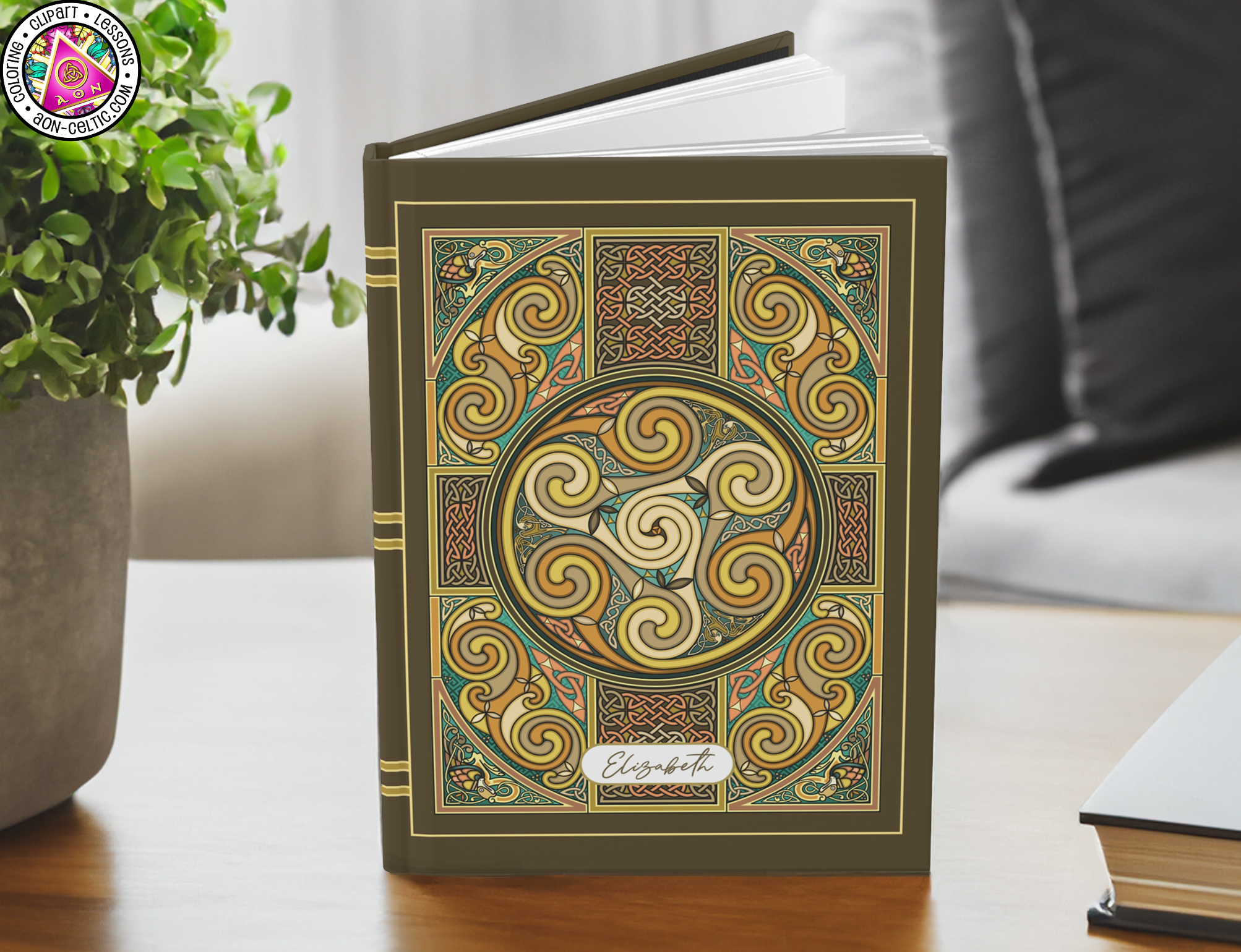 a book sitting on a table next to a potted plant