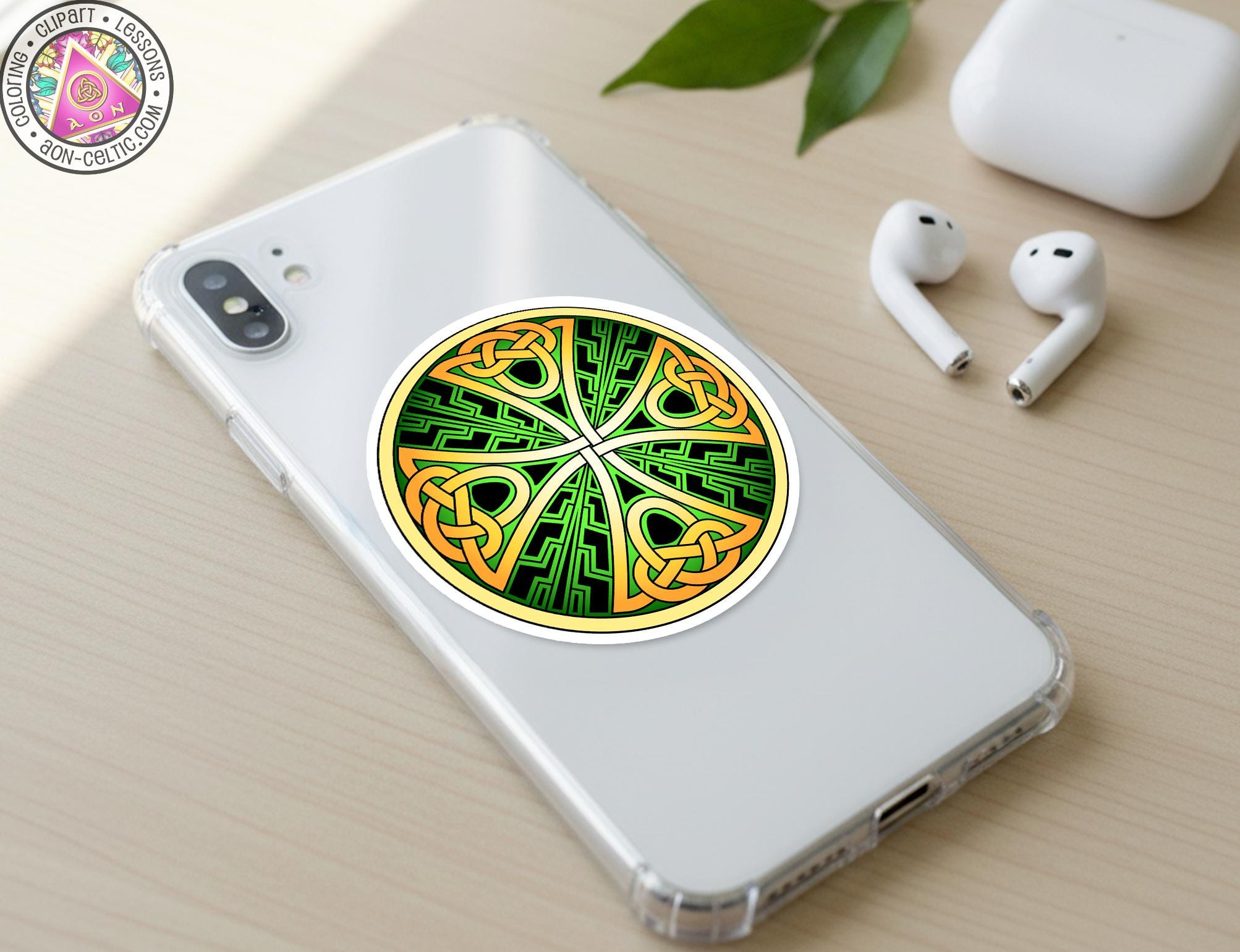 a smartphone with a sticker of a Celtic knot design on its back cover, along with a pair of white earbuds and a white phone case.