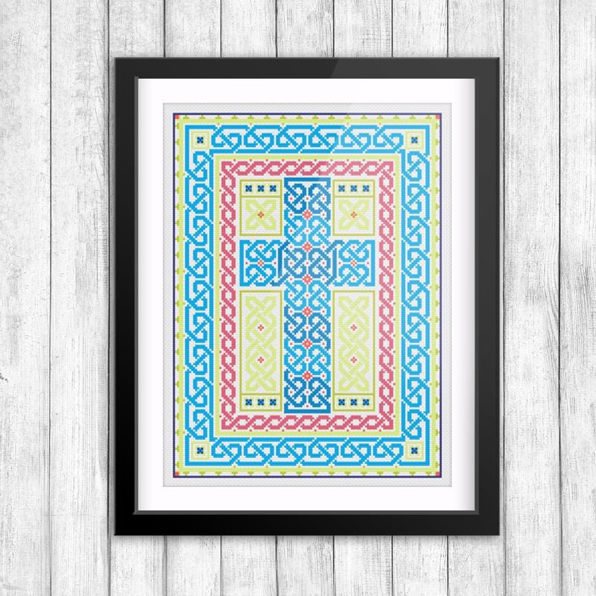The image is a framed artwork featuring a colorful, intricate design with various geometric shapes and patterns in shades of blue, red, yellow, and green.