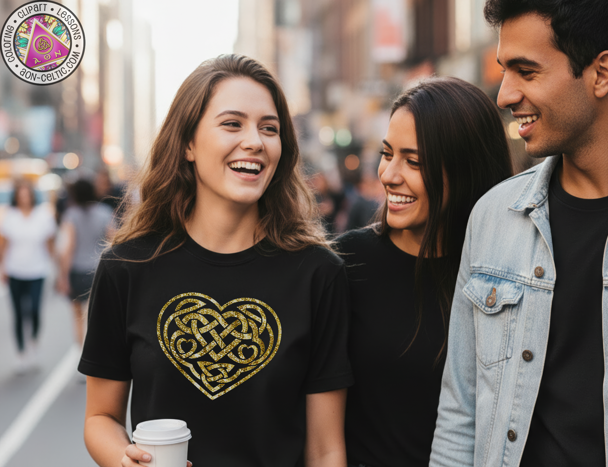 A group of three people, two women and one man, are walking together and smiling, with one woman wearing a black t-shirt with a heart design.