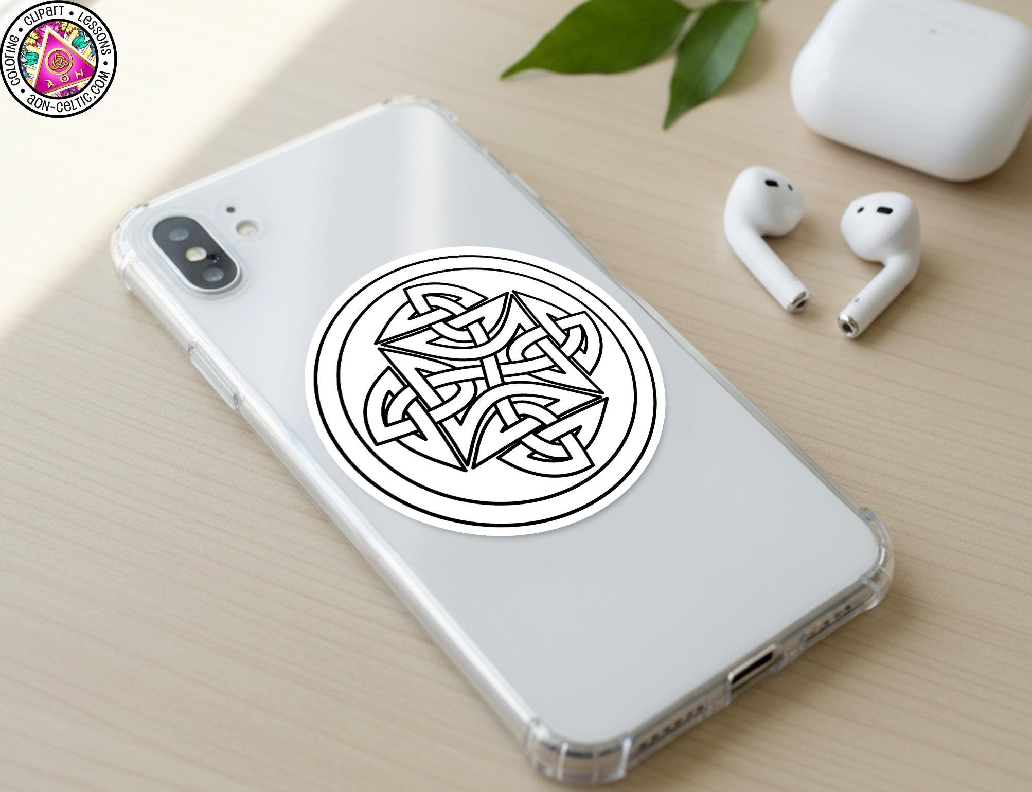 a smartphone with a sticker of a Celtic knot design on its back cover, along with a pair of white earbuds and a white phone case.