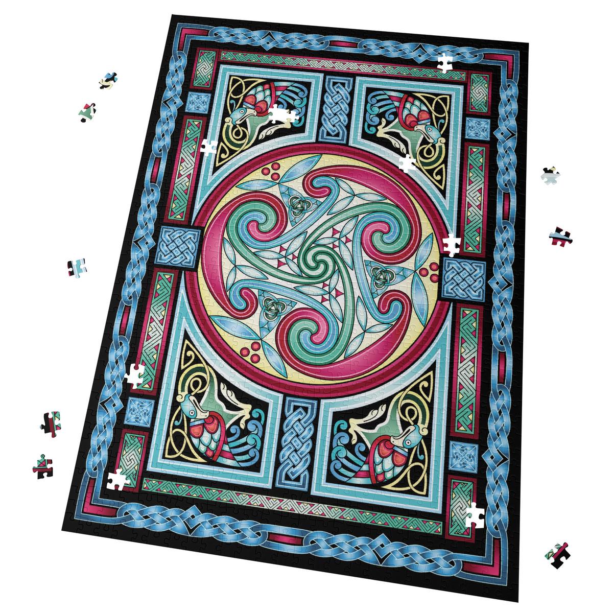 a colorful, intricate Celtic-inspired design with swirling patterns and geometric shapes in shades of blue, pink, green, and yellow. The design is framed by a border of blue and pink, and scattered puzzle pieces are visible around the edges.