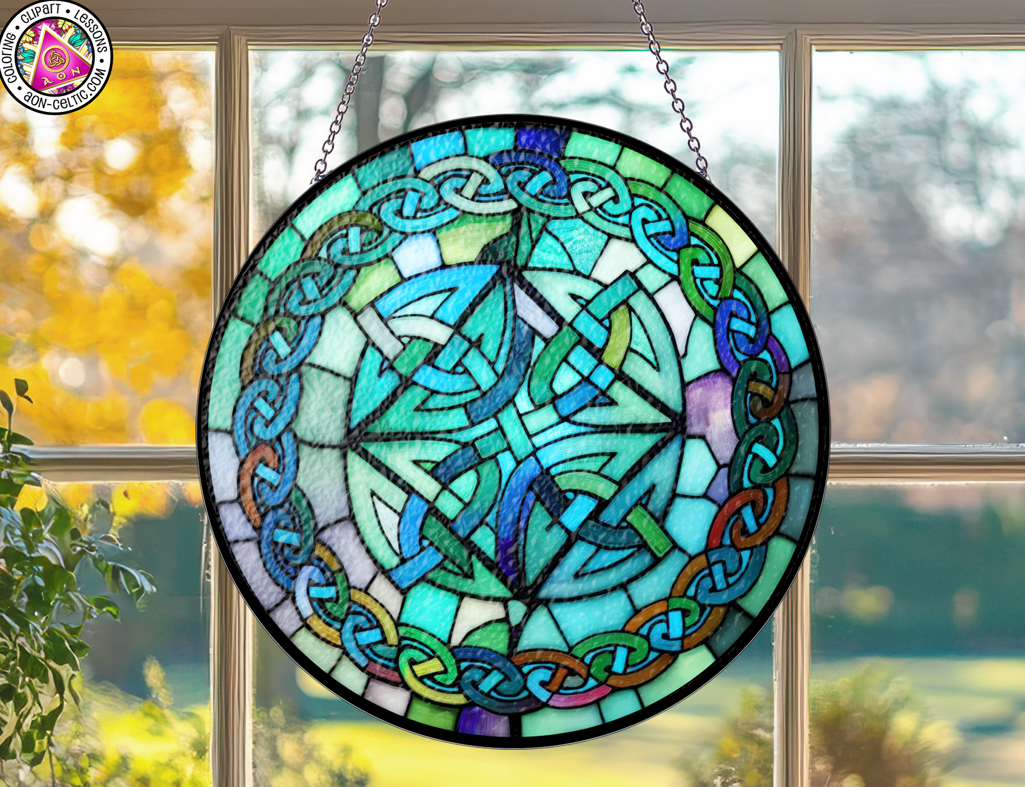a stained glass sun catcher hanging from a window