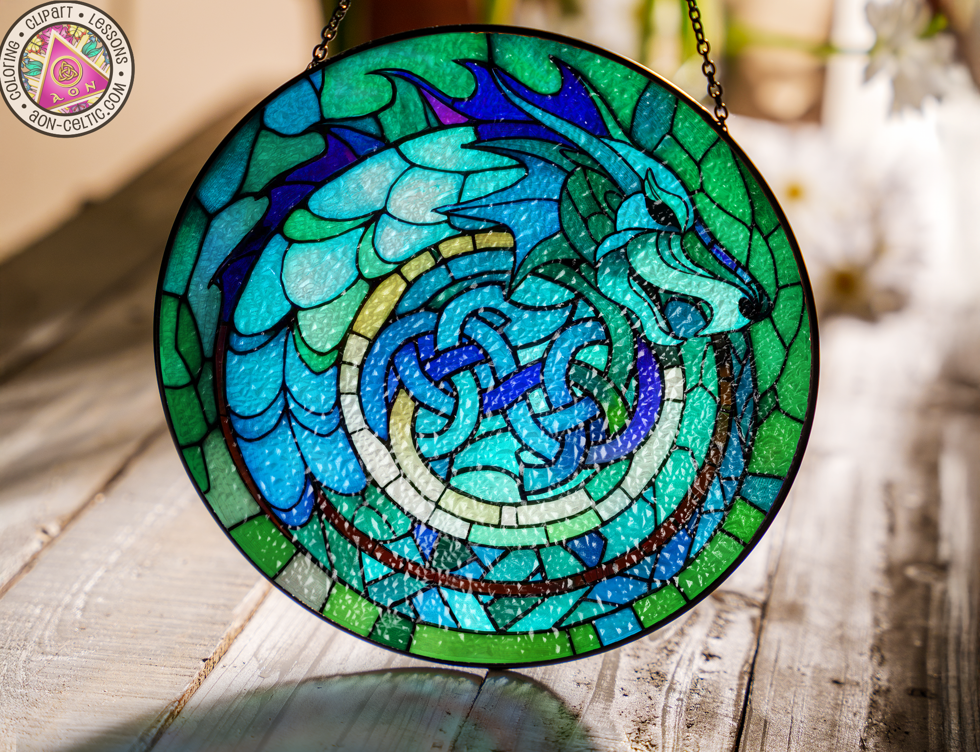 a circular stained glass window hanging on a chain