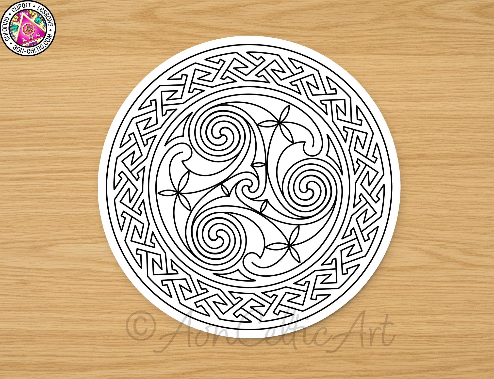 A circular design featuring intricate swirls and floral elements, presented on a wooden surface.