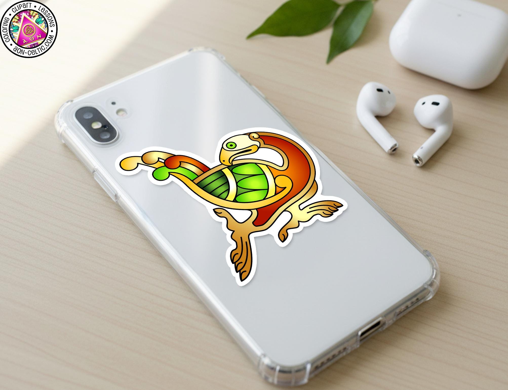 a smartphone with a colorful sticker on the back cover, along with a pair of white earbuds and a white phone case.