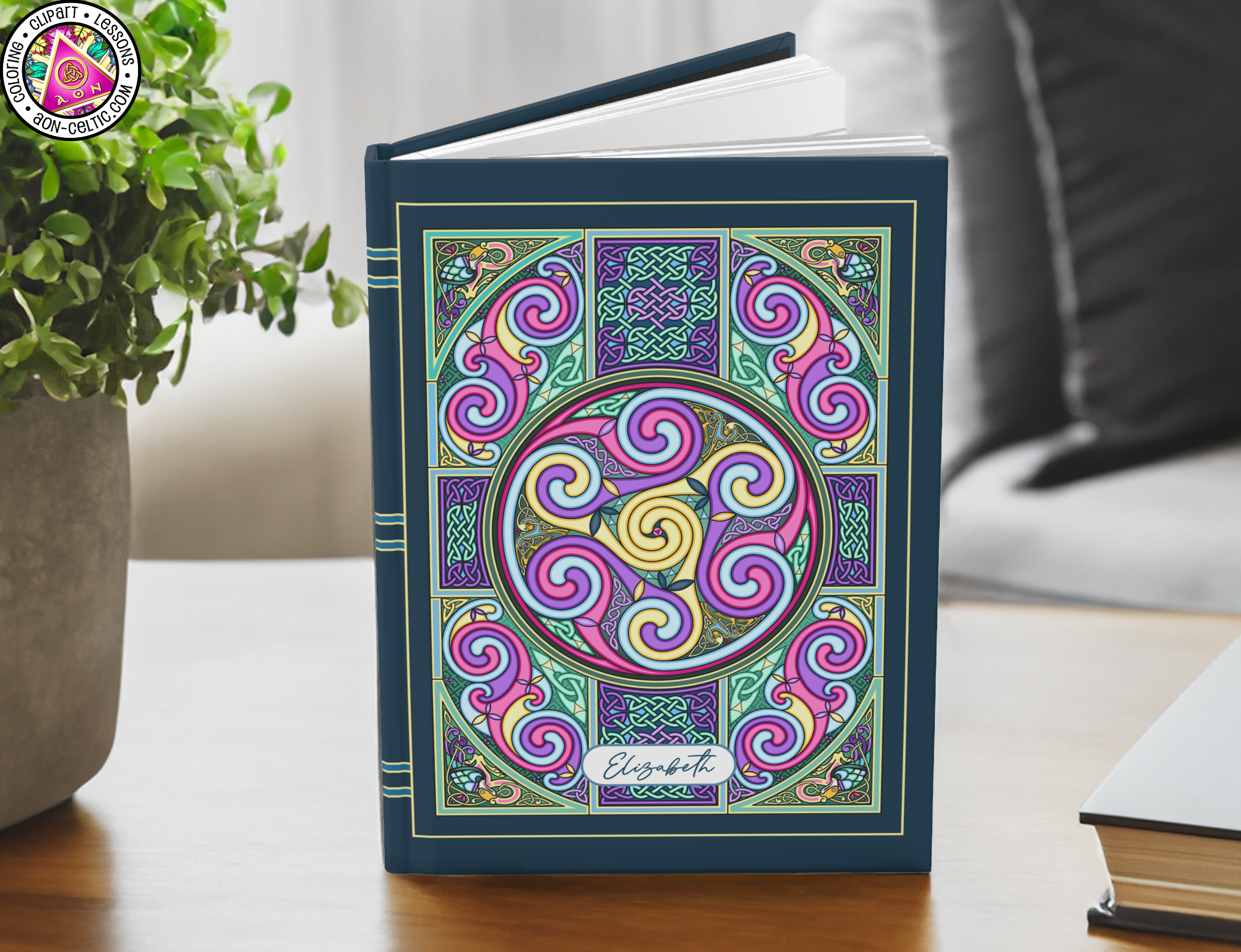 a book sitting on a table next to a potted plant