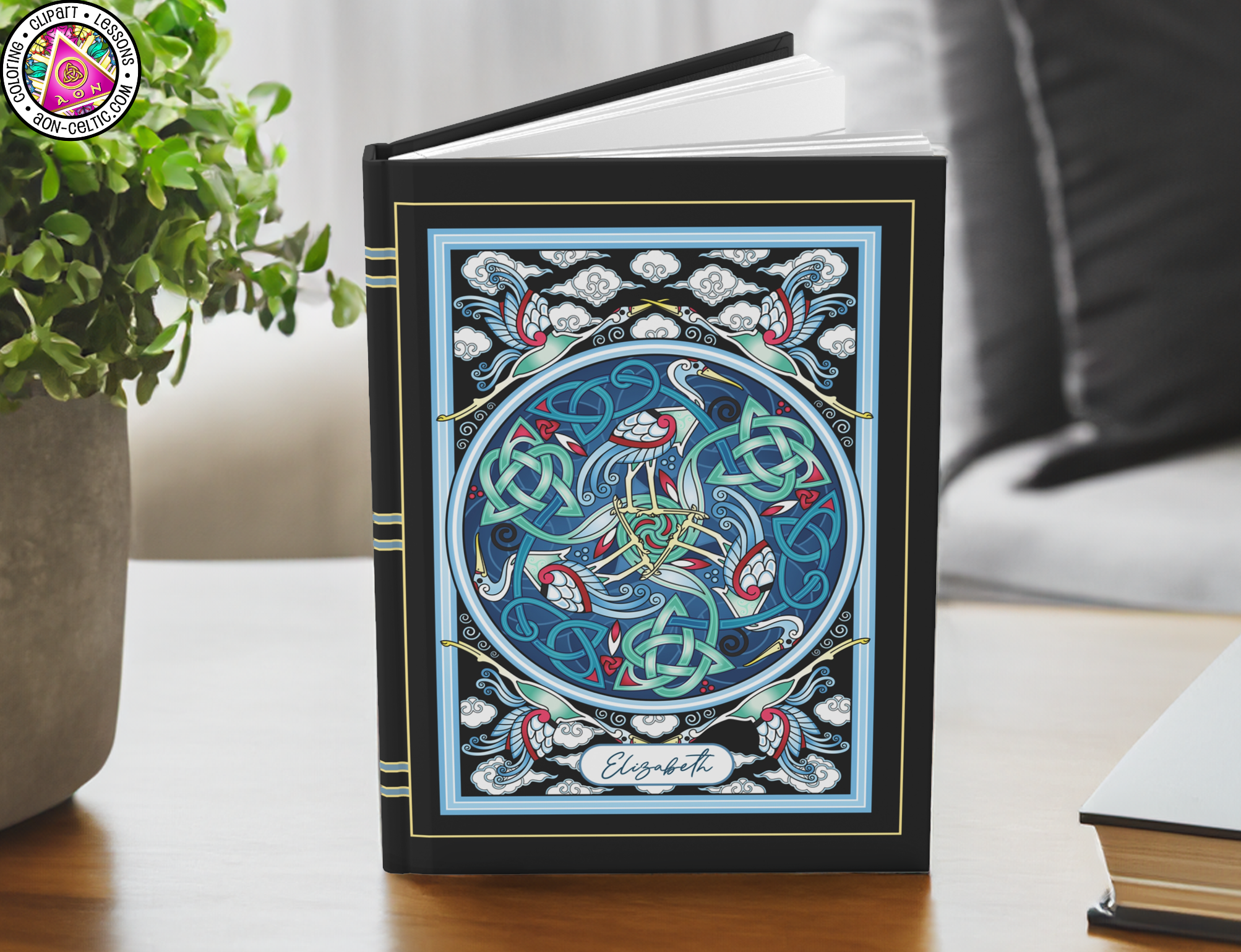 a book sitting on top of a table next to a potted plant