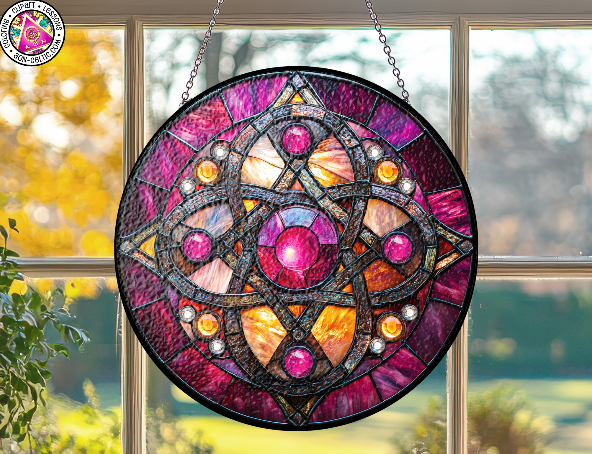 a stained glass sun catcher hanging from a window