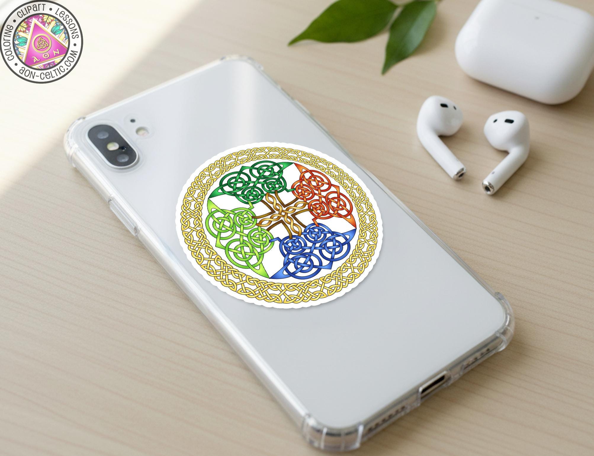 a smartphone with a colorful sticker on the back cover, along with a pair of earbuds and a white earbud case on a wooden surface.