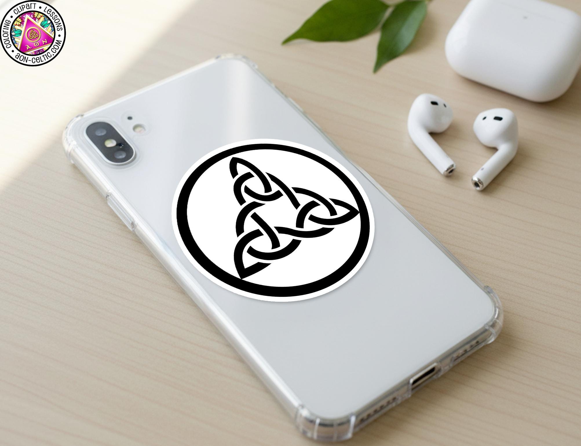 a smartphone with a sticker of a Celtic knot on its back cover, along with a pair of earbuds and a white earbud case.
