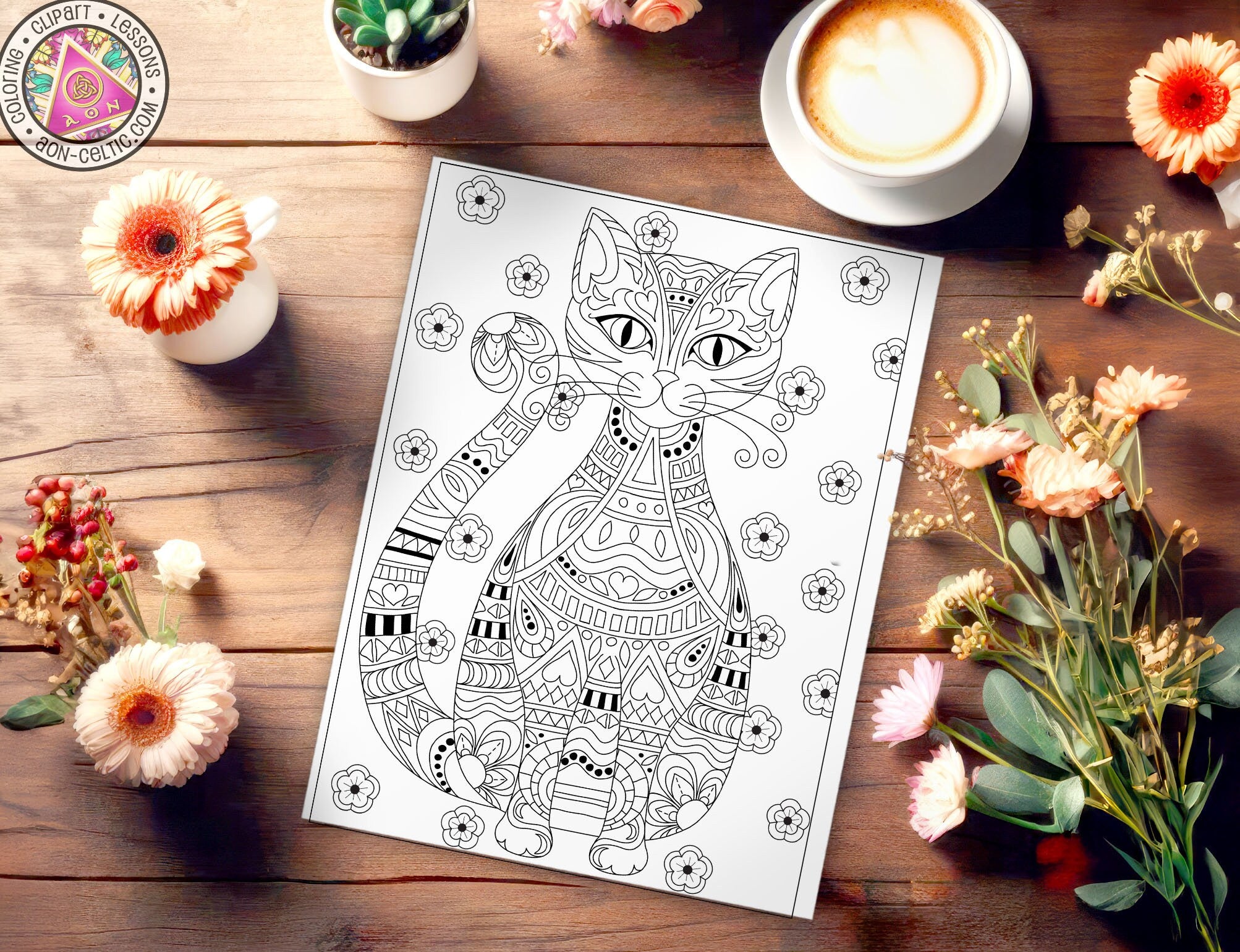 a coloring book on a table with flowers and a cup of coffee