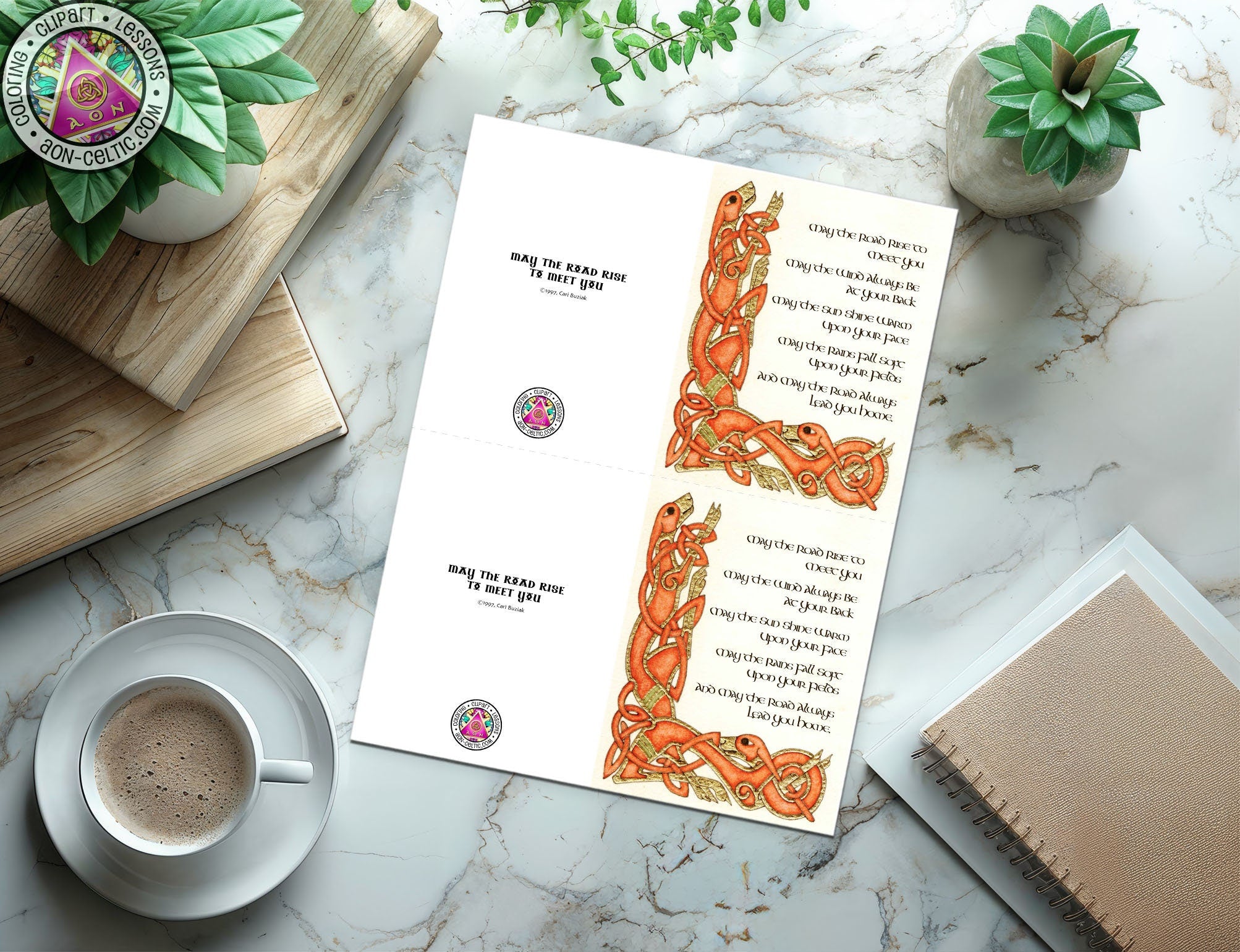 a cup of coffee sitting on top of a table next to a book